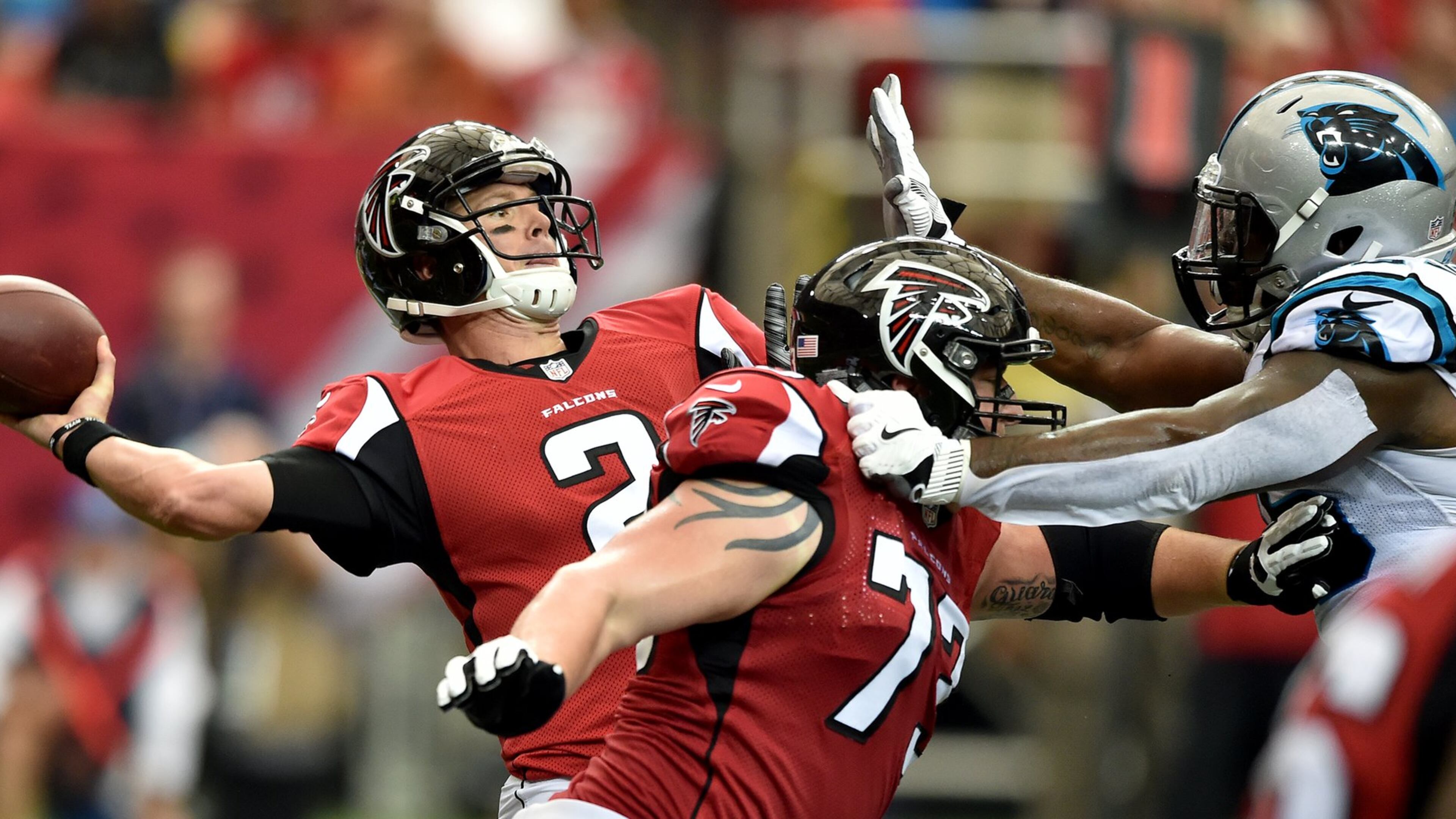 Falcons quarterback Matt Ryan throw deep under pressure from Carolina Panthers defensive tackle Kawann Short during the first quarter in the Georgia Dome Sunday Oct. 2, 2016. BRANT SANDERLIN/BSANDERLIN@AJC.COM