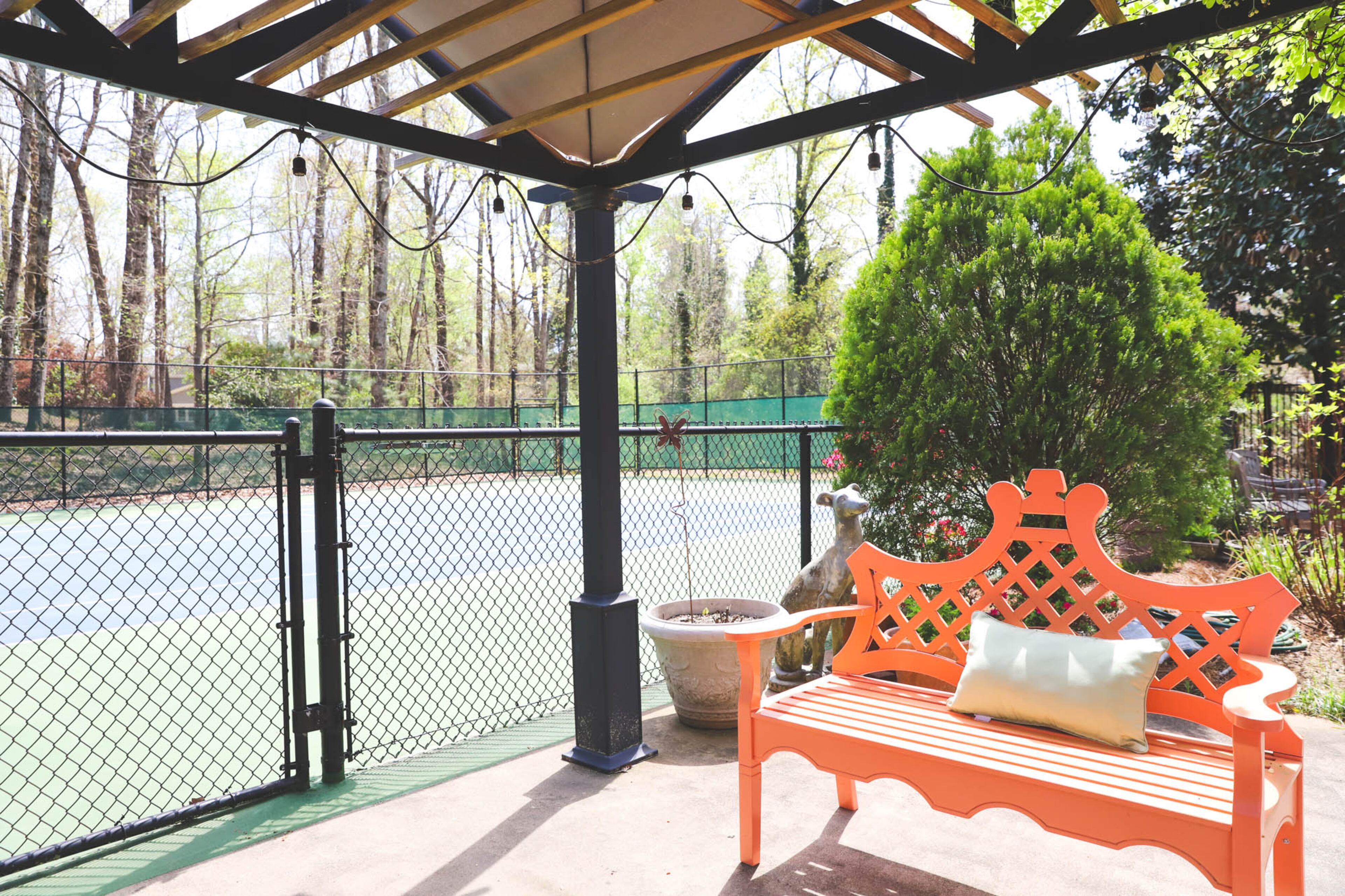 The tennis court in John and Jane Hall’s backyard was there when they purchased their home in 2012, and they’ve resurfaced it using Signature Tennis Courts, Inc several times since they moved in. The court gets regular use, particularly from John’s mens’ league that plays there most weeks. Text by Shannon Dominy/Photo by Reynolds Rogers