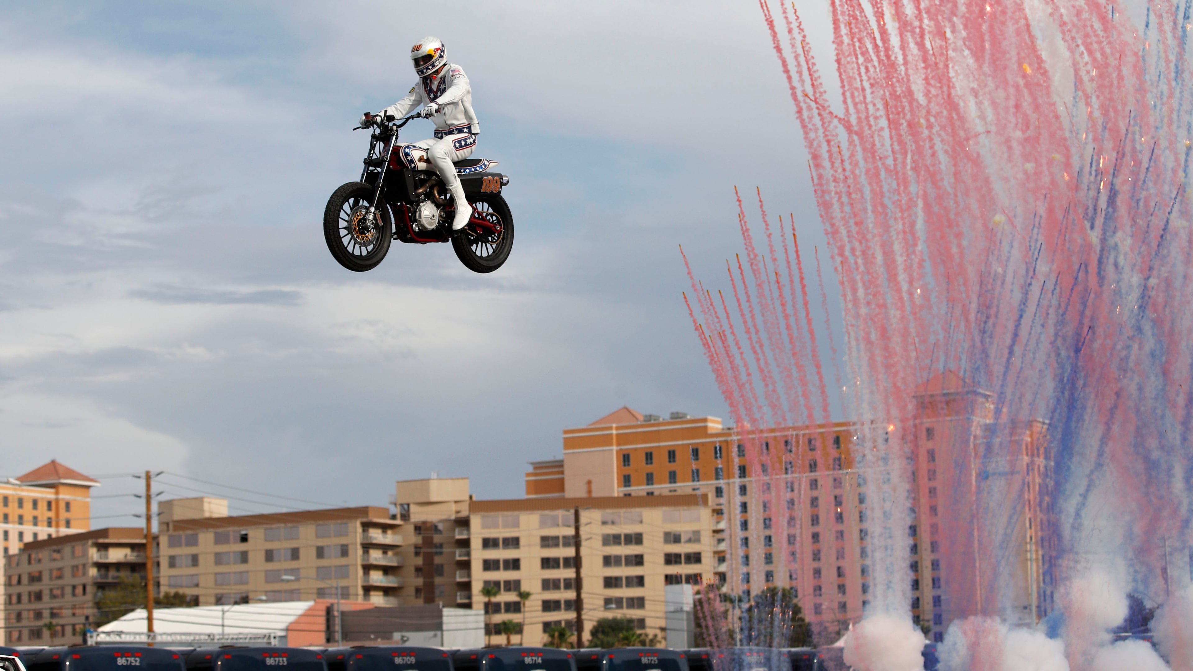 Travis Pastrana jumps a row of crushed cars on a motorcycle Sunday, July 8, 2018, in Las Vegas.