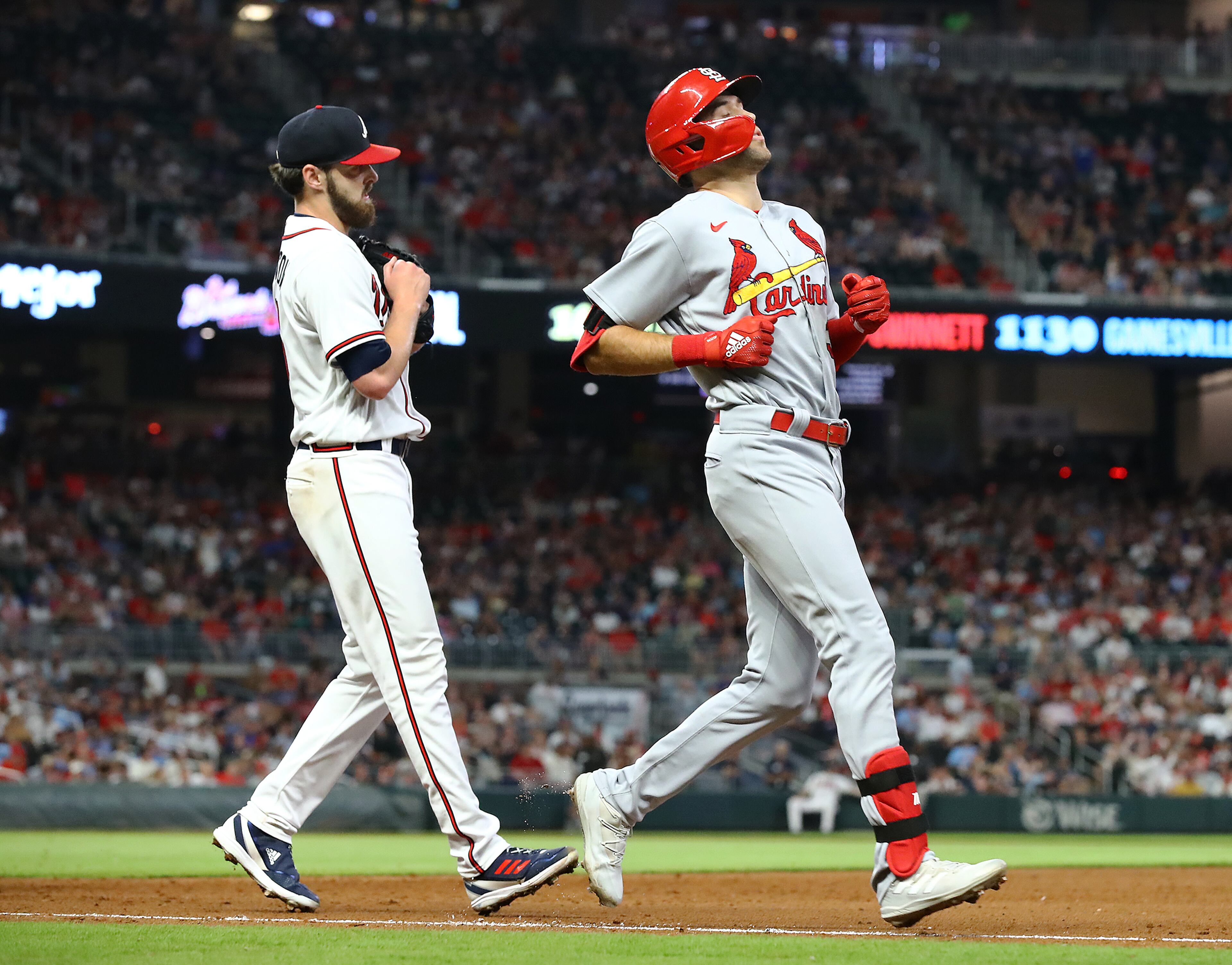 St. Louis Cardinals outfielder Dylan Carlson reacts after losing the foot race to Atlanta Braves starting pitcher Ian Anderson (left) on a ground ball for out three with the bases loaded during the fifth inning in a MLB baseball game on Tuesday, July 5, 2022, in Atlanta. The Cardinals fell to the Braves 7-1. “Curtis Compton / Curtis.Compton@ajc.com”