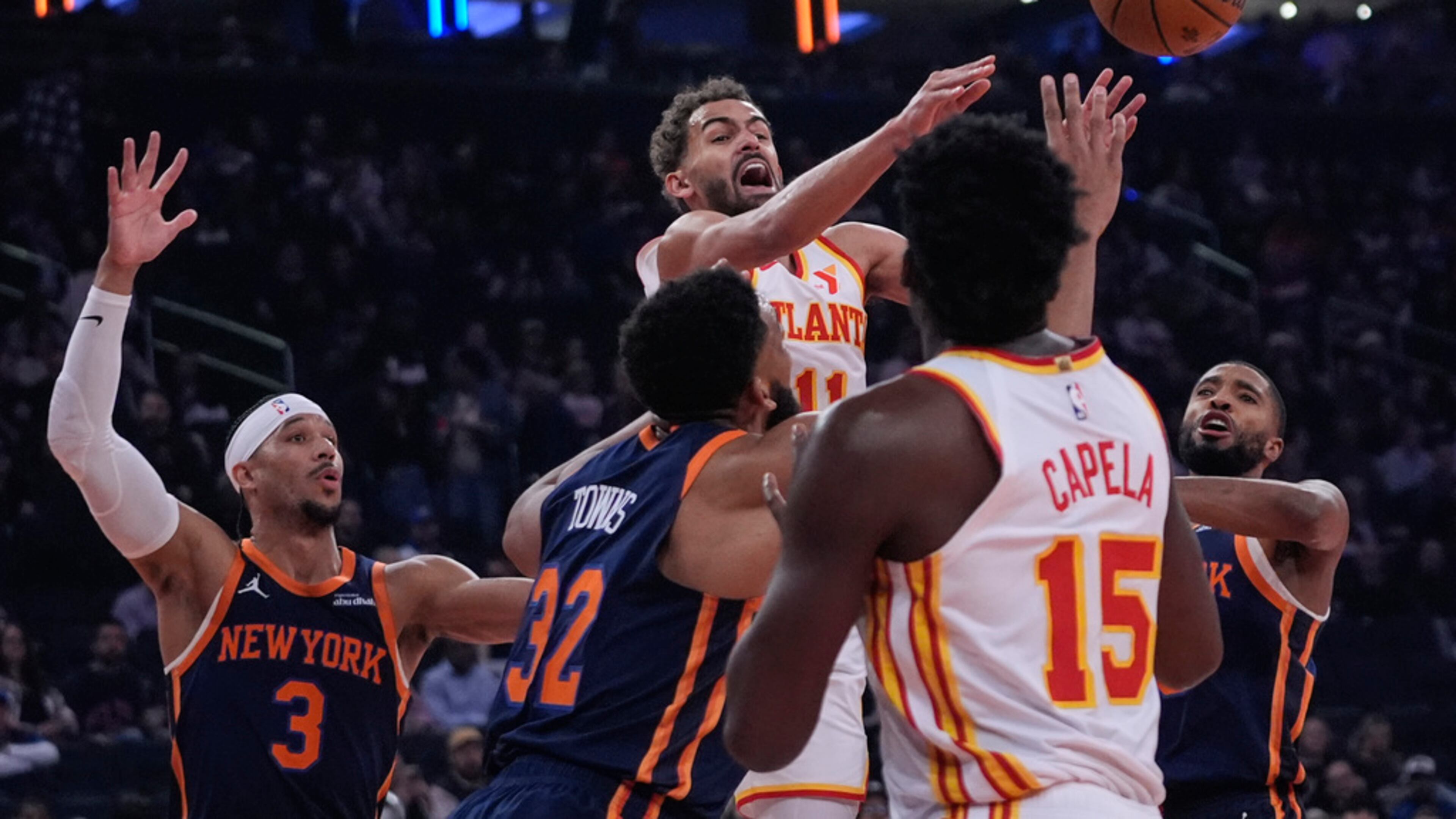 Atlanta Hawks' Trae Young (11) passes away from New York Knicks' Mikal Bridges (25), Karl-Anthony Towns (32) and Josh Hart (3) during the first half of an Emirates NBA Cup basketball game Wednesday, Dec. 11, 2024, in New York. (AP Photo/Frank Franklin II)
