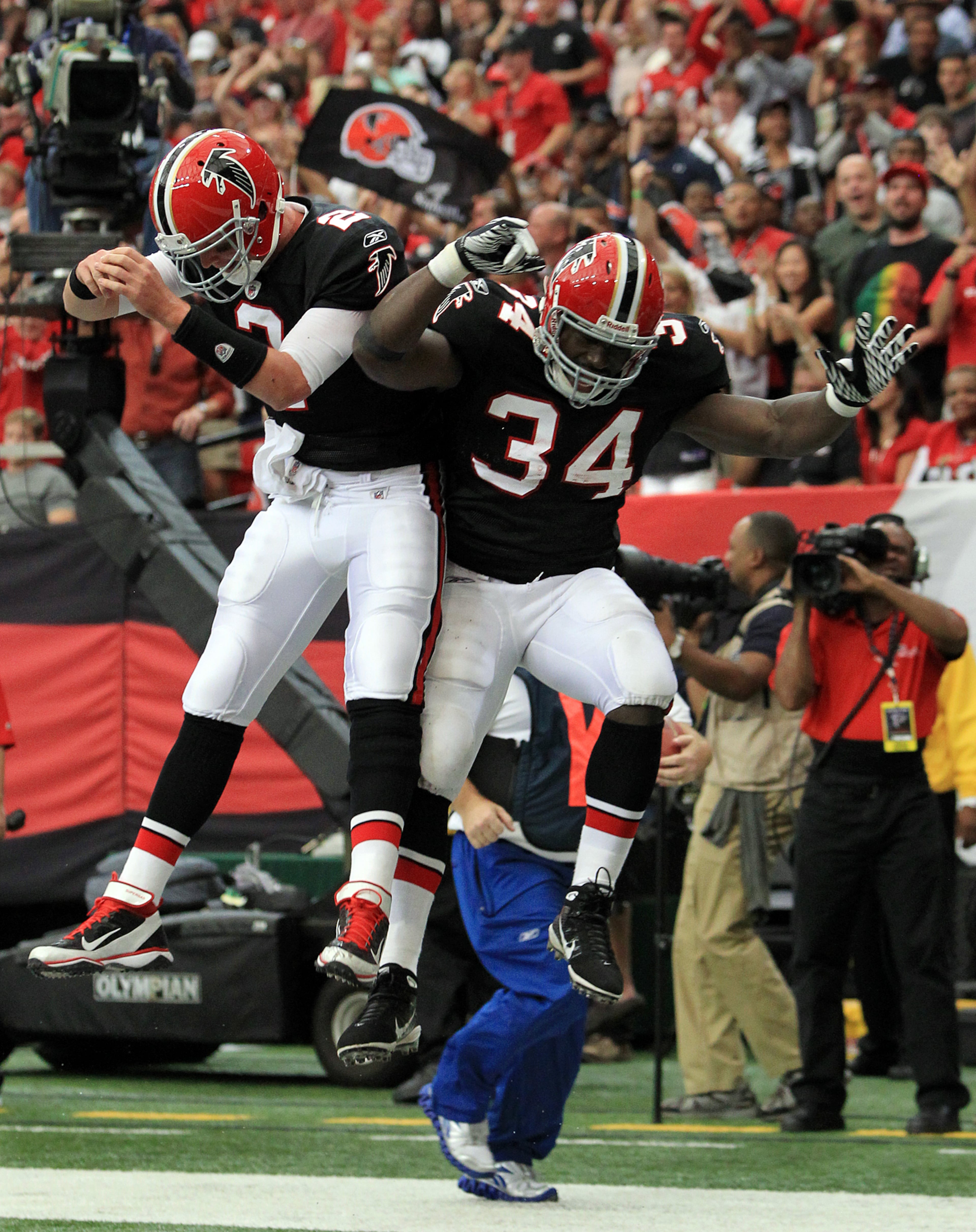 Falcons quarterback Matt Ryan (left) celebrates with fullback Ovie Mughelli after teaming up on a short TB pass in 2011. Curtis Compton ccompton@ajc.com
