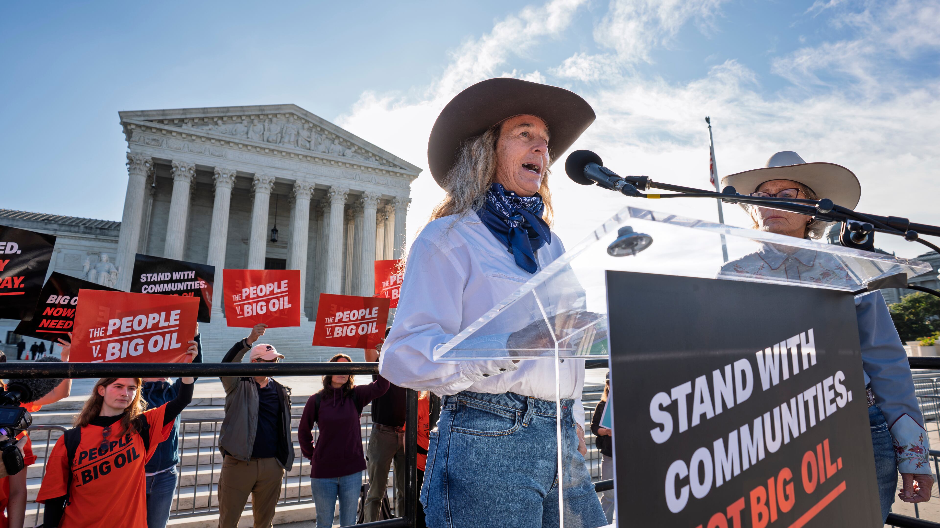 Colorado rancher Kathryn Bedell talks about the impact of droughts on her business as activists gather at the Supreme Court for a case about whether oil and gas companies should help pay for damage caused by disasters linked to climate change, on Capitol Hill in Washington, Monday, Oct. 5, 2026. (AP Photo/J. Scott Applewhite)