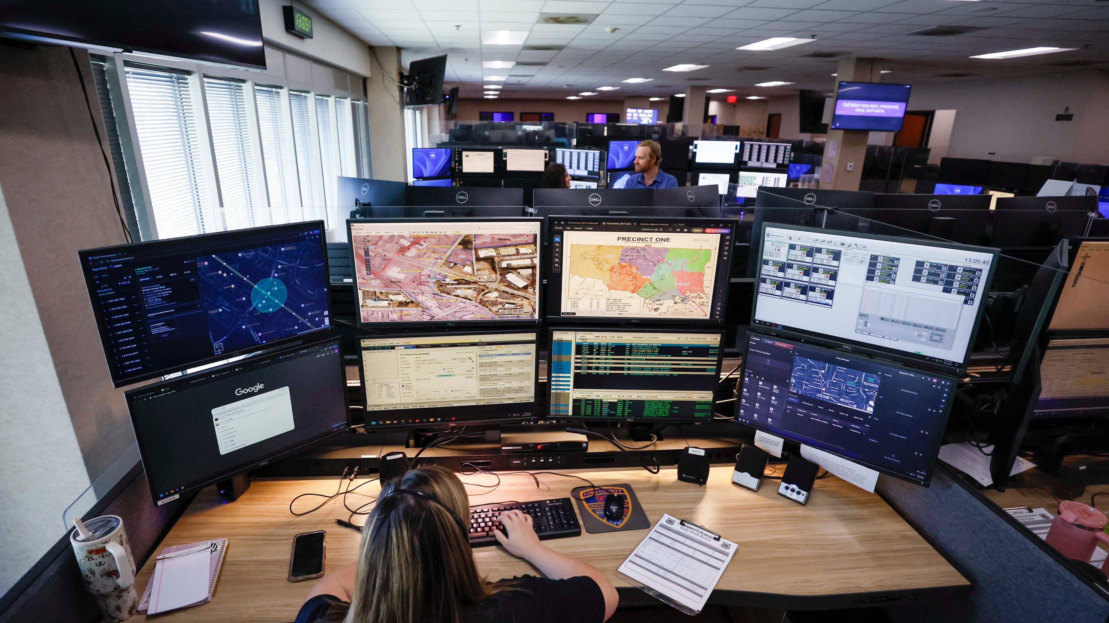 Emergency Communication Officer Julianna Shetterly is seen operating eight screens during her shift on Thursday, October 2, 2025. In August, the Cobb County 911 call center upgraded its systems with new technology, which includes the ability to receive video feeds from callers and utilize GIS to locate them. (Miguel Martinez/ AJC)