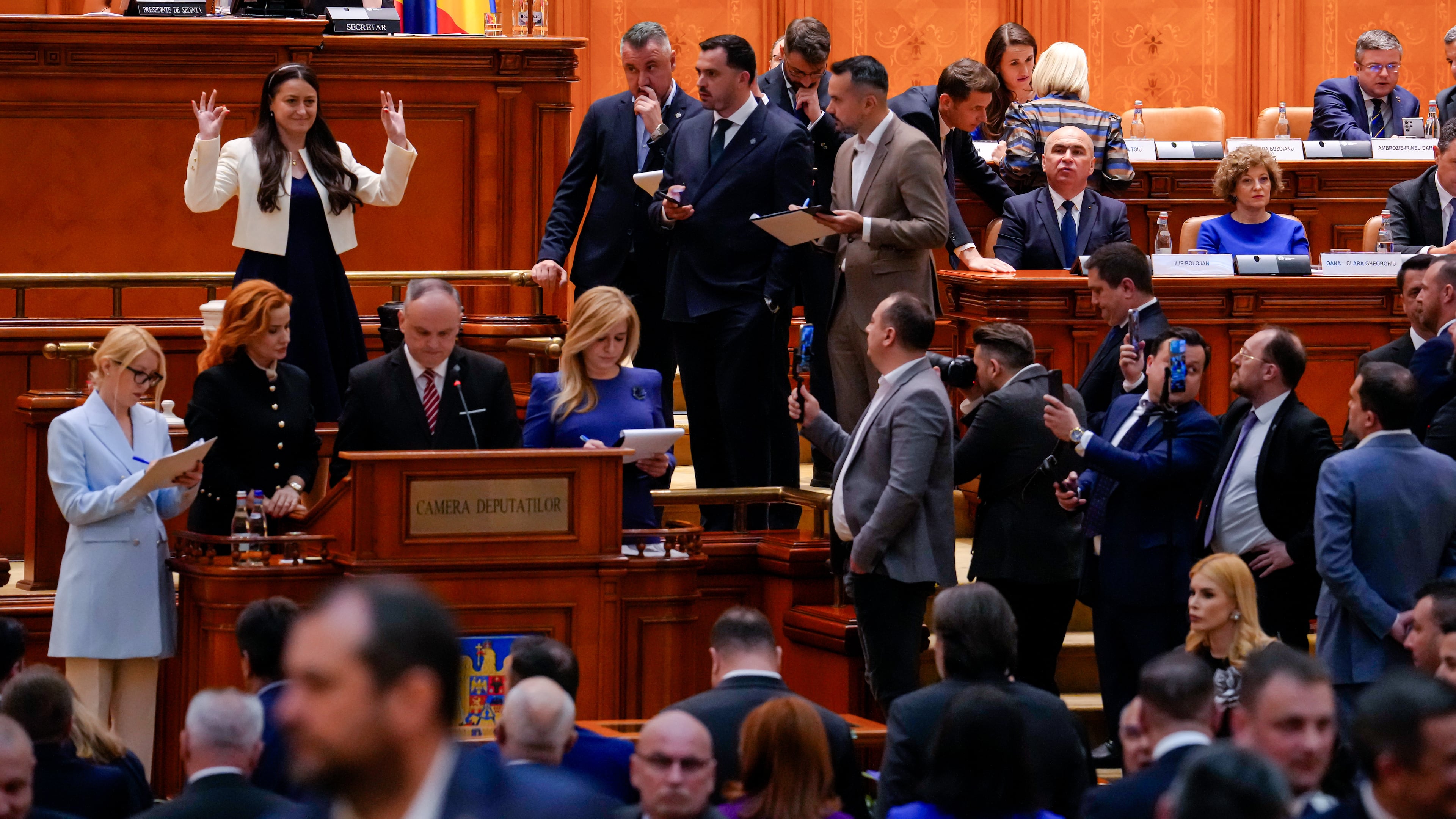 Romanian Prime Minister Ilie Bolojan, centre row third from right, sits as lawmakers vote during a no confidence vote in Bucharest, Romania, Tuesday, May 5, 2026. (AP Photo/Vadim Ghirda)