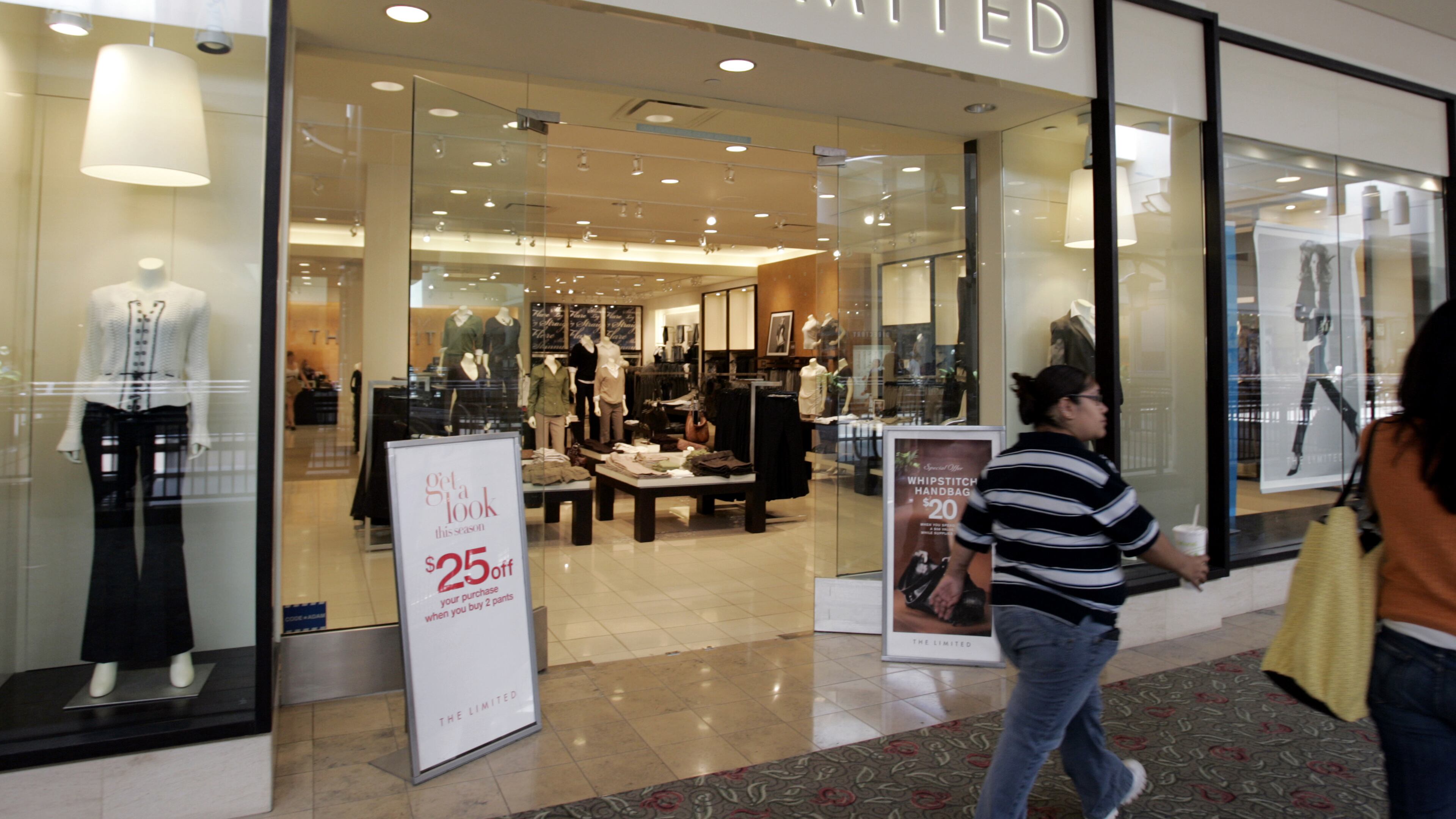 FILE - In this Aug. 14, 2006 file photo, shoppers walk by The Limited store in San Jose, Calif. More grim news for malls as women's apparel designer and retailer The Limited says it will close all its brick-and-mortar stores at the end of this weekend. The New Albany, Ohio company says it will continue to operate online only after the Jan. 8, 2017 closures. (AP Photo/Paul Sakuma)