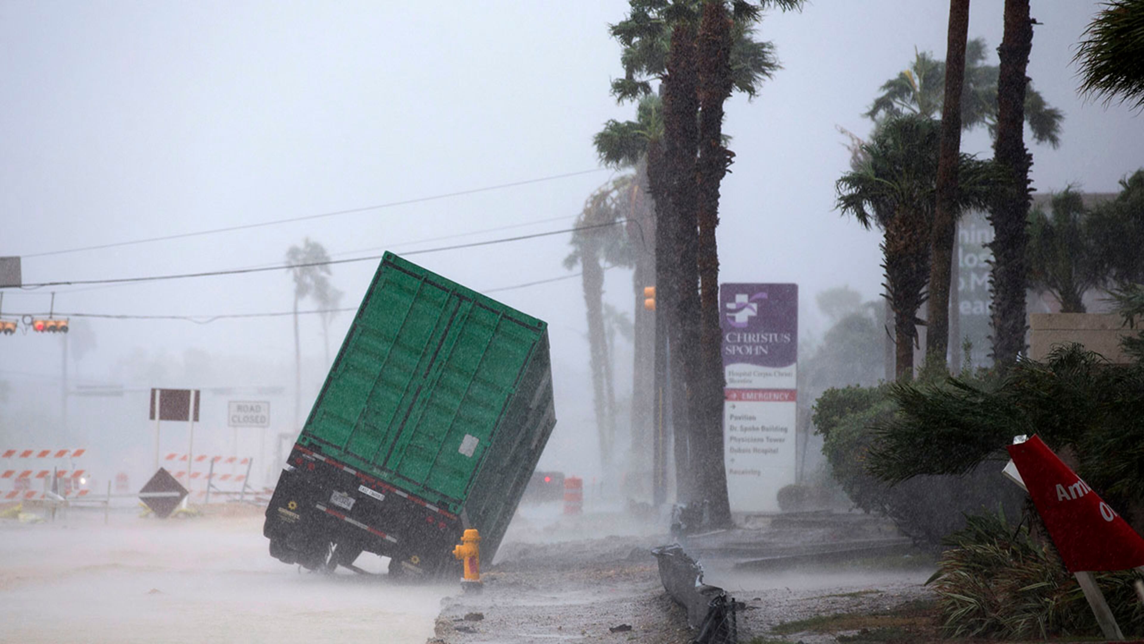 A power generator tips in front of Texas' CHRISTUS Spohn Hospital in Corpus Christi, Texas, as Hurricane Harvey hits Friday, Aug. 25, 2017. (Courtney Sacco /Corpus Christi Caller-Times via AP)