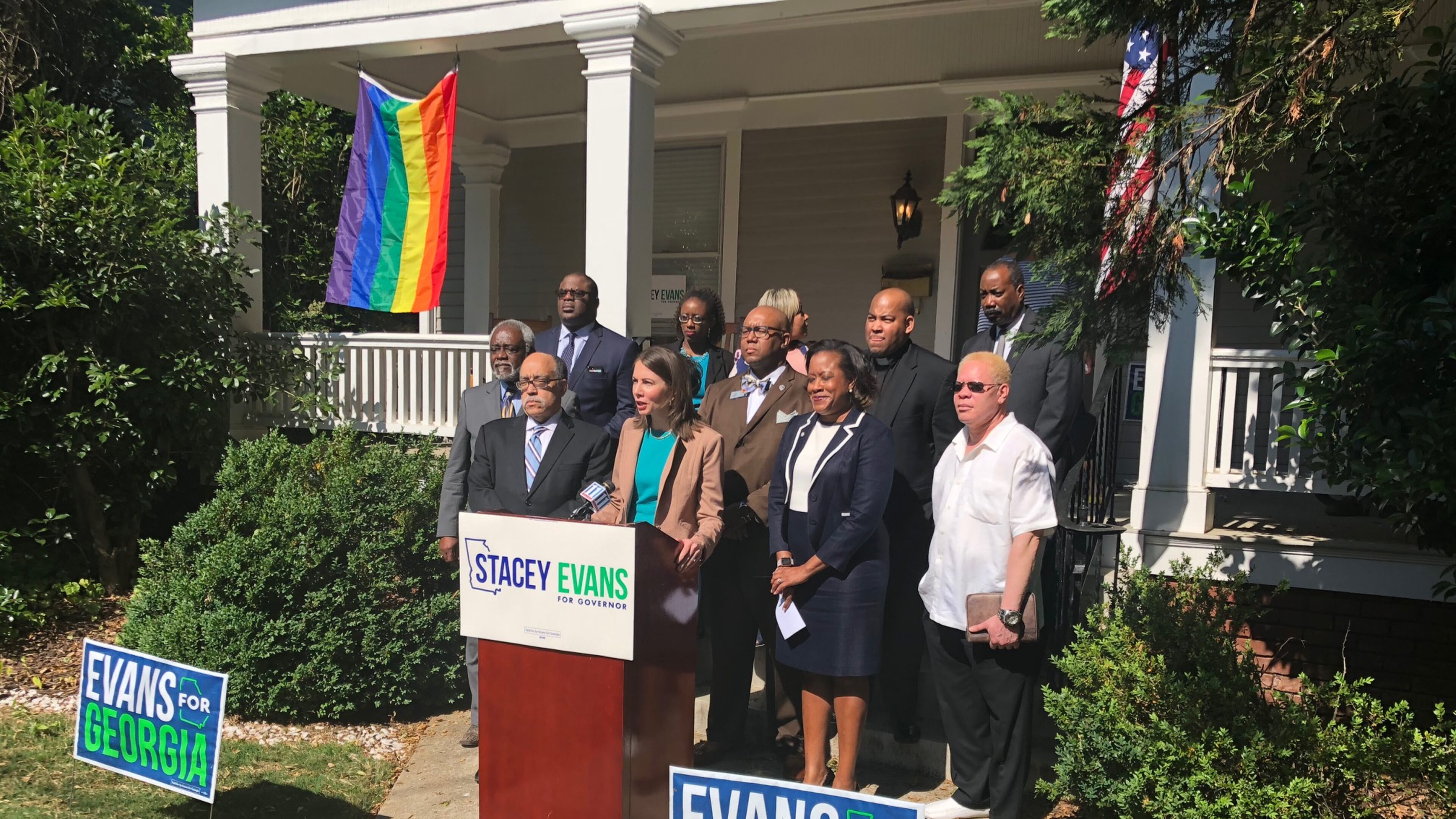 Democrat Stacey Evans is flanked by supporters at her campaign headquarters. AJC/Greg Bluestein