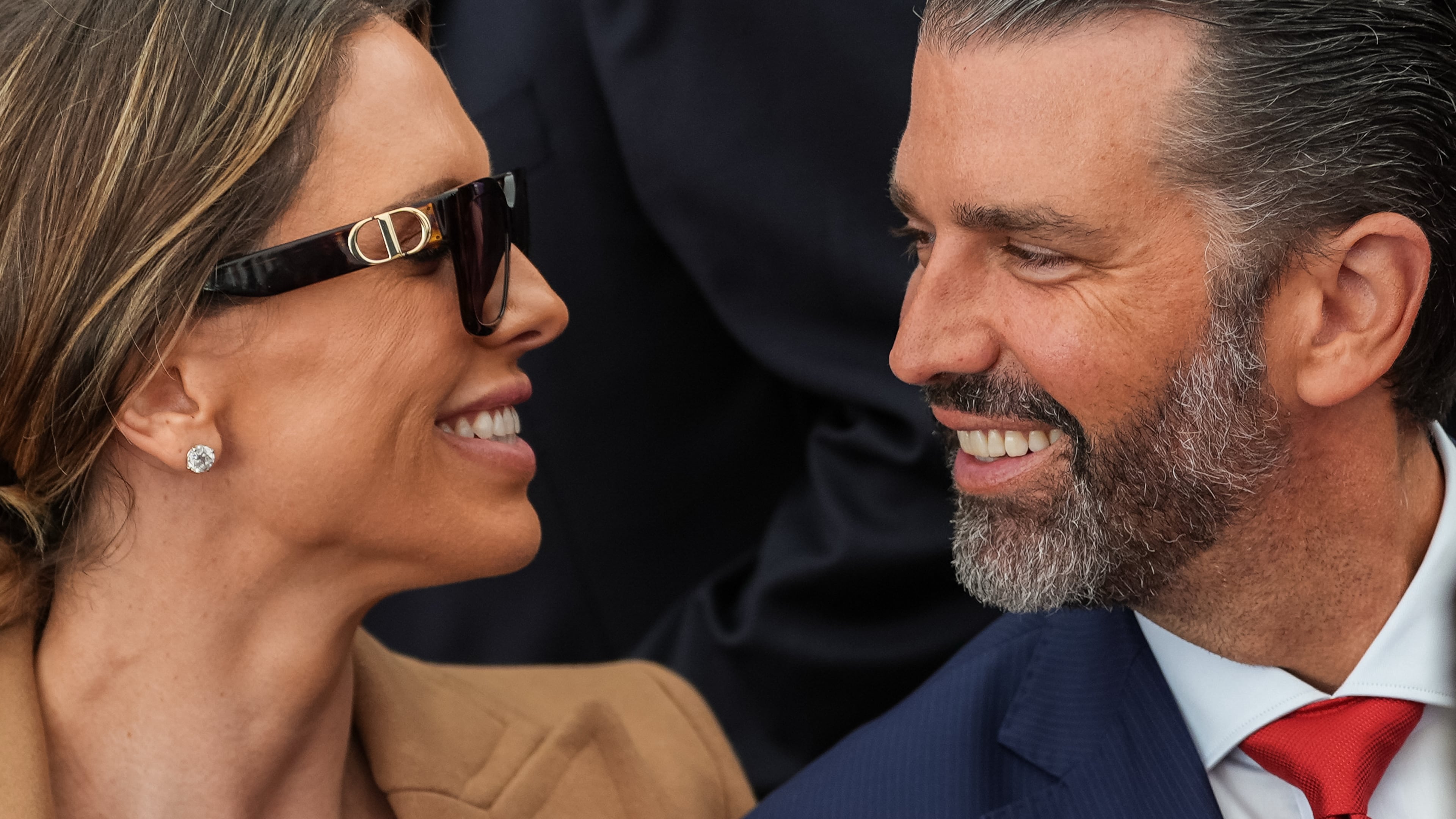 Donald Trump Jr. and his wife Bettina Anderson look at each other while waiting for President Donald Trump to speak at Deerfield Residence, the residence of the U.S. Ambassador to Ireland Edward S. Walsh, Saturday, Sept. 12, 2026, in Dublin. (AP Photo/Julia Demaree Nikhinson)