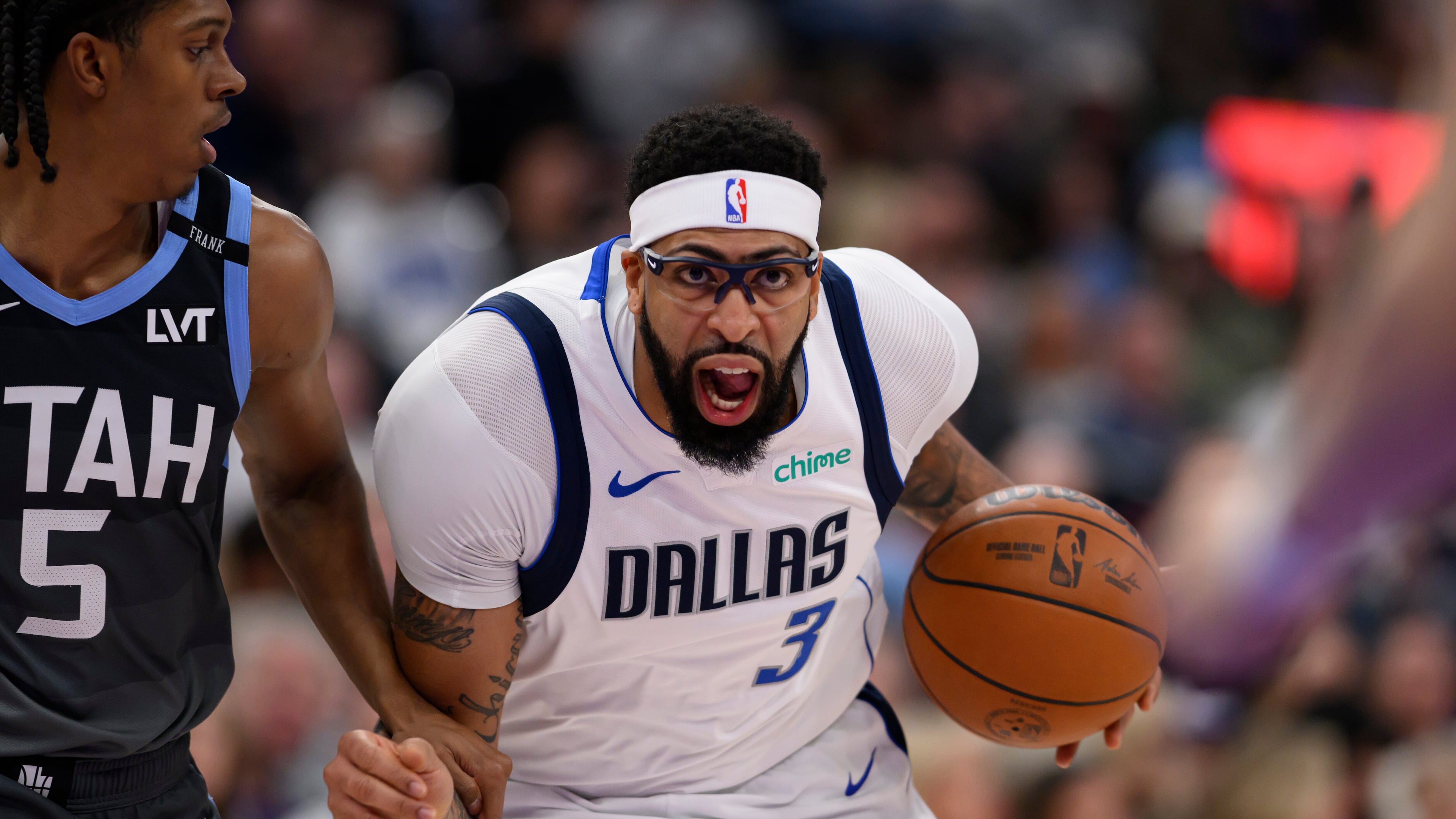 Dallas Mavericks forward Anthony Davis (3) drives to the basket while guarded by Utah Jazz forward Cody Williams (5) during the first half of an NBA basketball game, Thursday, Jan. 8, 2026, in Salt Lake City. (AP Photo/Tyler Tate)