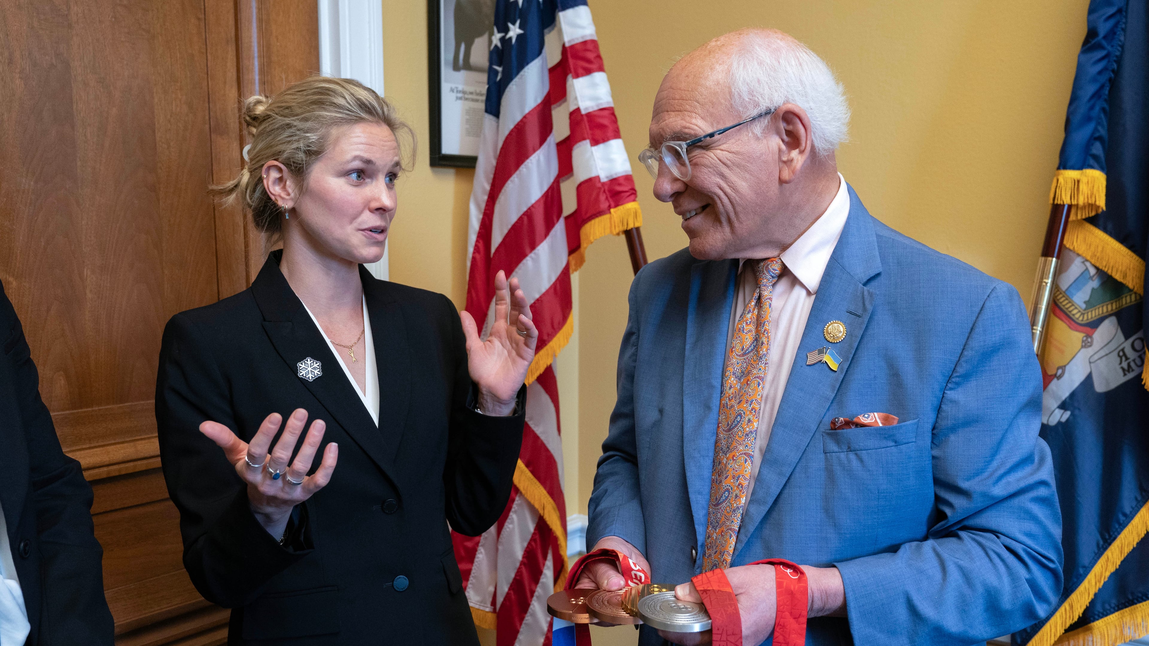 Rep. Paul Tonko, D-N.Y., speaks with Olympian Jessie Diggins as she shows him her medals during a meeting to advocate for clean air, clean water and a healthy planet on Capitol Hill Tuesday, June 23, 2026, in Washington. (AP Photo/Jose Luis Magana)