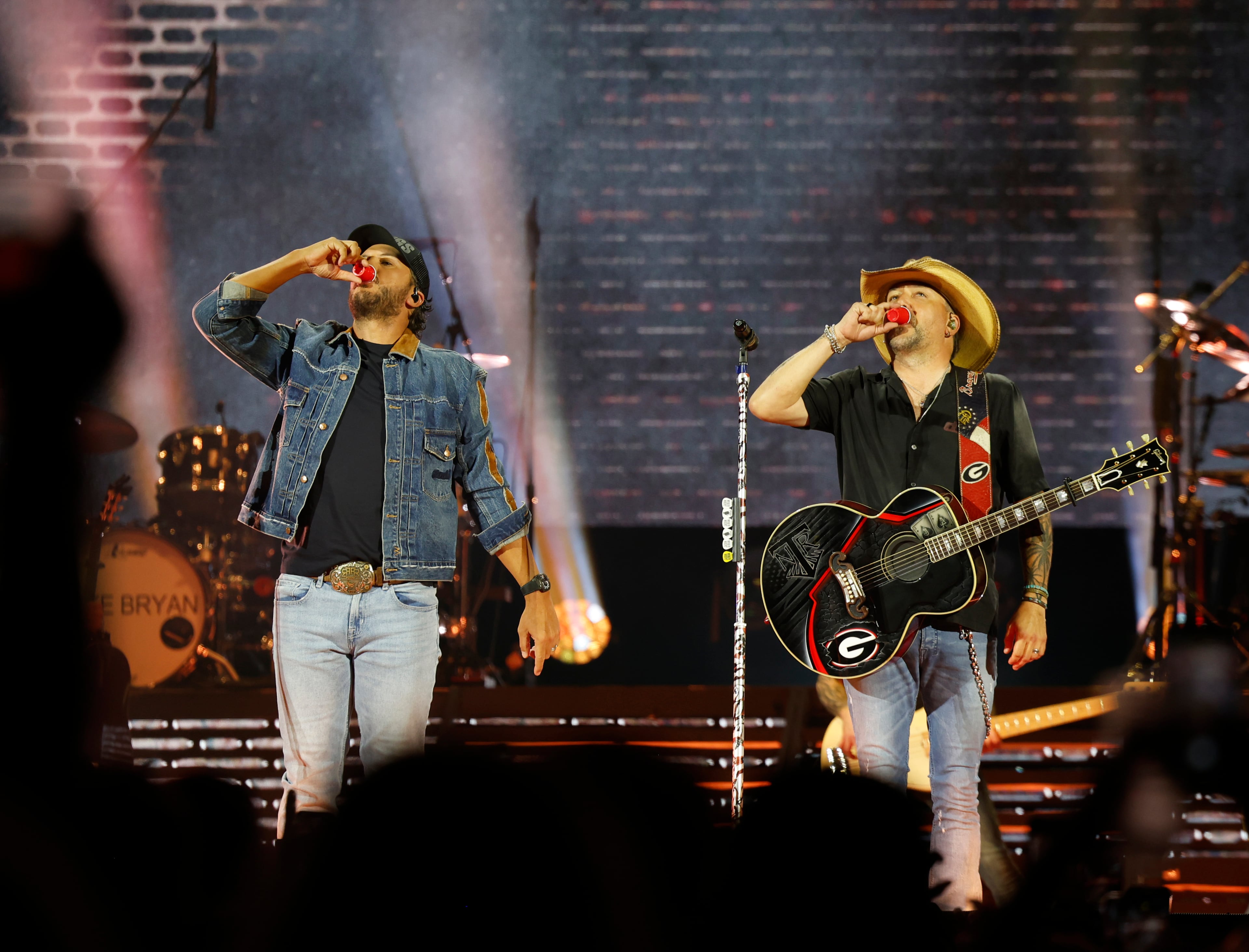 Georgia natives Jason Aldean (right) and Luke Bryan celebrate performing together for the first "Live Between the Hedges Concert Presented by PruittHealth" at Sanford Stadium, home of the University of Georgia football team, Saturday, April 25, 2026. (Akili-Casundria Ramsess/EyeAkili Media)