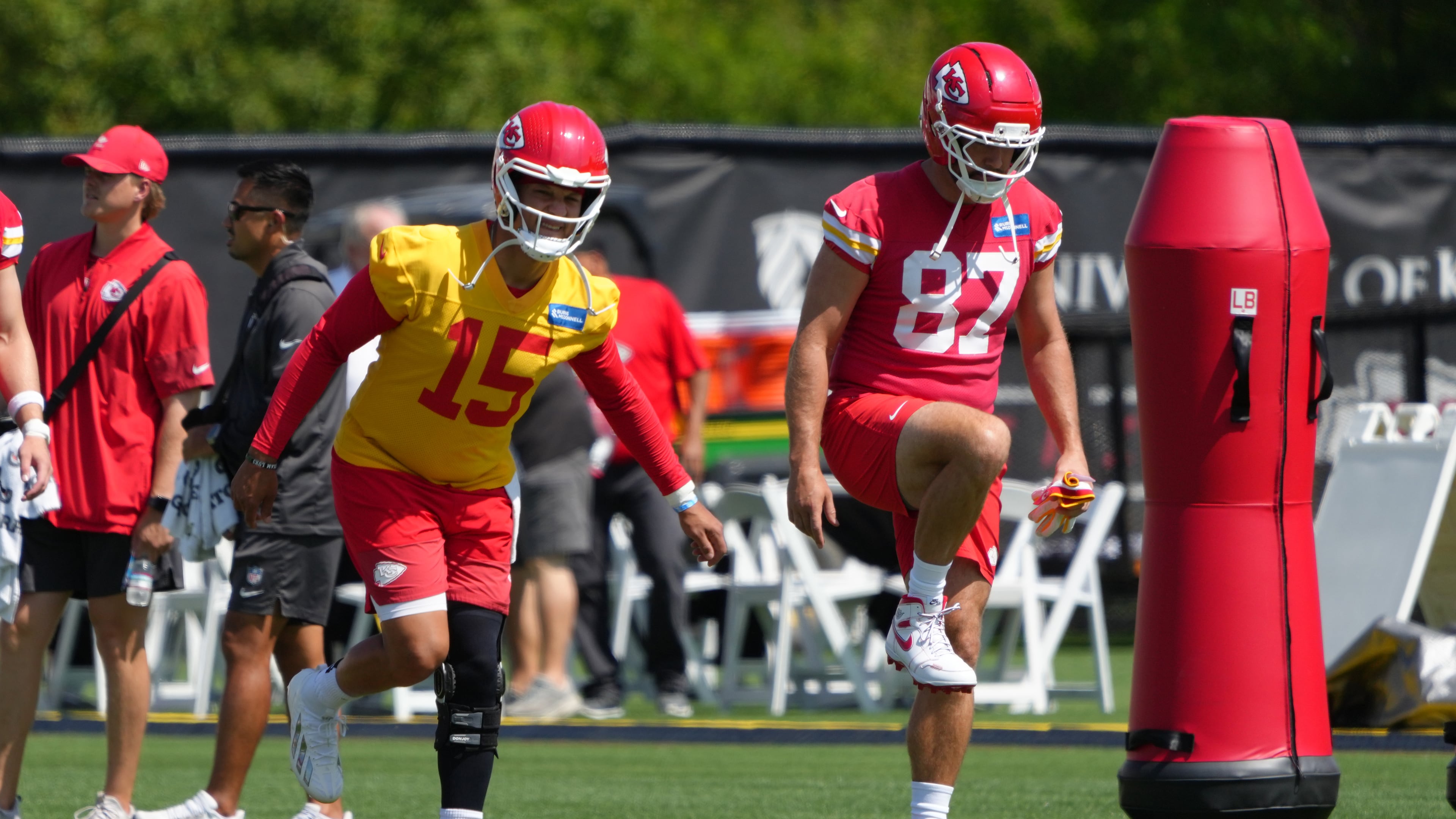 Kansas City Chiefs quarterback Patrick Mahomes (15) and tight end Travis Kelce (87) stretch out during the NFL football team's practice Tuesday, June 9, 2026, in Kansas City, Mo. (AP Photo/Ed Zurga)