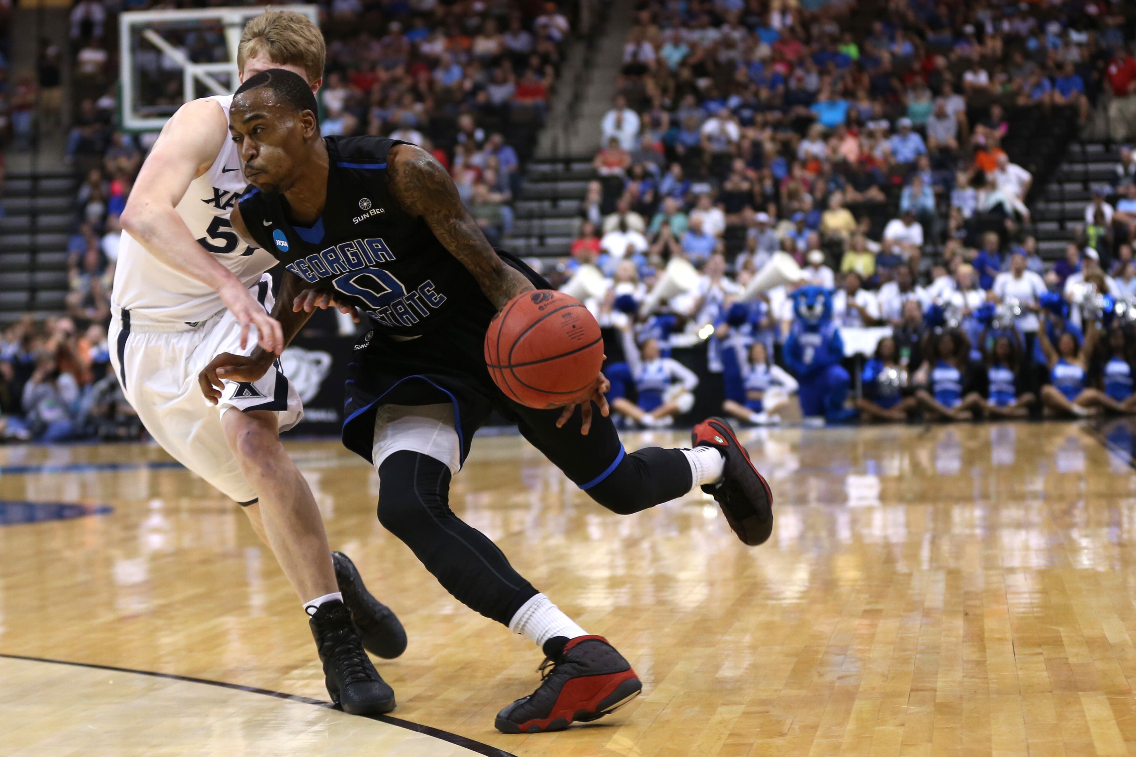 JACKSONVILLE, FL - MARCH 21: Kevin Ware #0 of the Georgia State Panthers dribbles past J.P. Macura #55 of the Xavier Musketeers in the first half during the third round of the 2015 NCAA Men's Basketball Tournament at Jacksonville Veterans Memorial Arena on March 21, 2015 in Jacksonville, Florida. (Photo by Mike Ehrmann/Getty Images)
