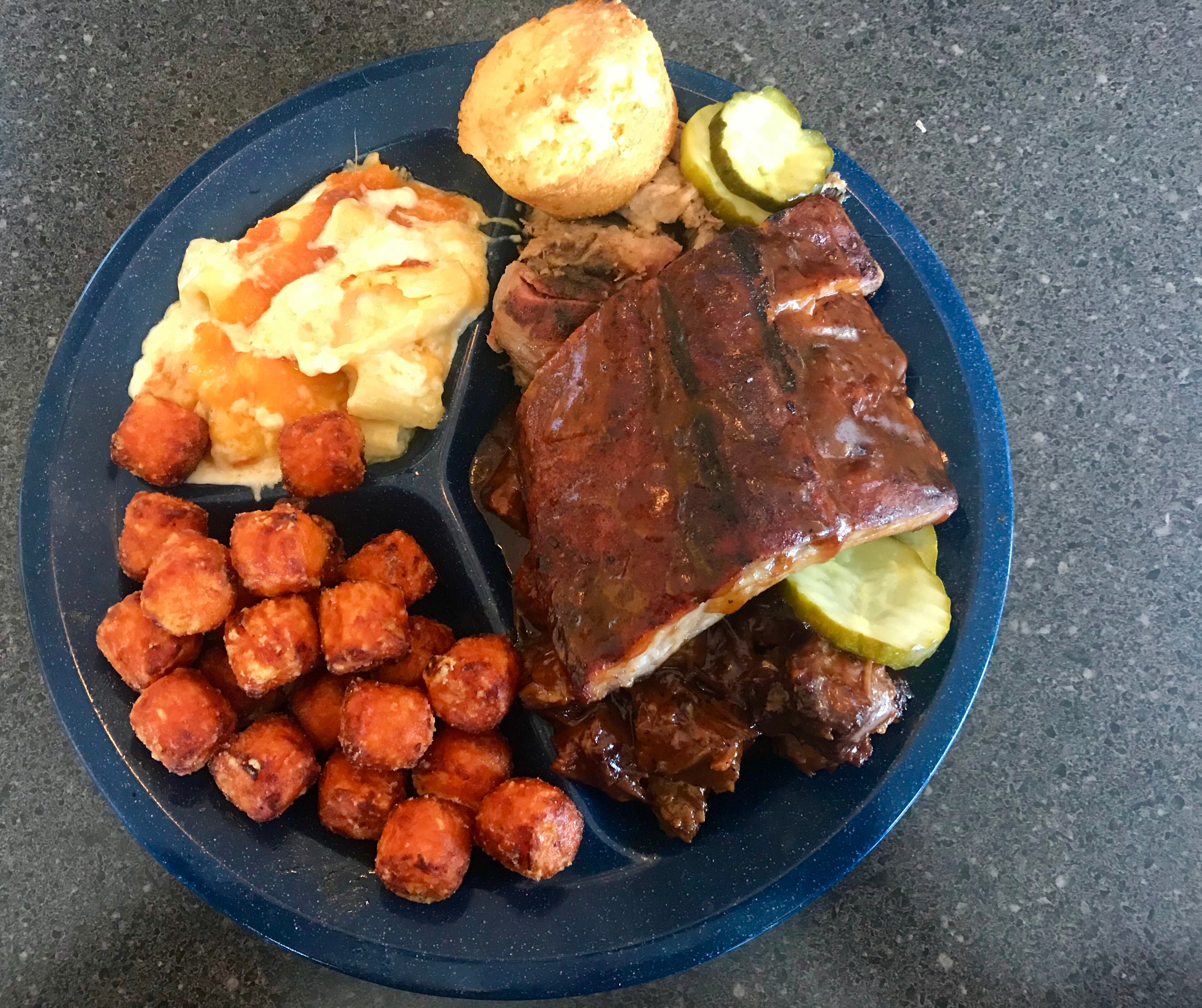 This meat combination plate from Sam's BBQ-1 in East Cobb includes pulled pork, wet-burnt ends, baby back ribs, sweet tator tots, mac-and-cheese and a corn muffin.