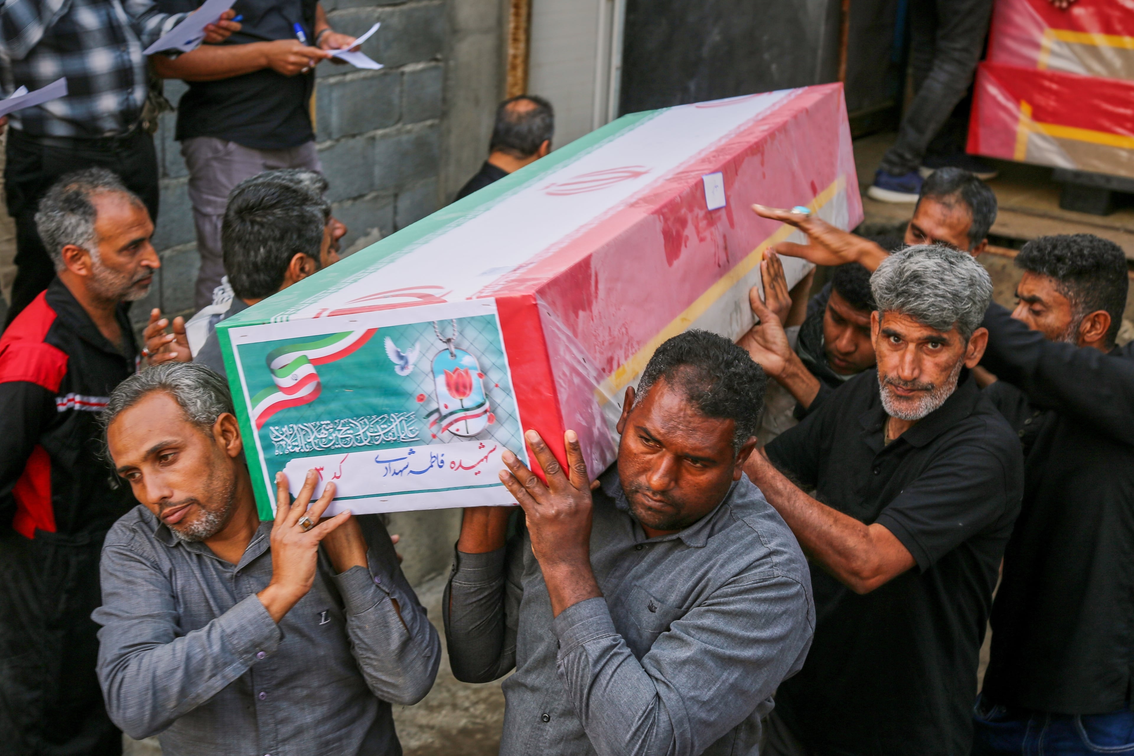 A coffin is carried during the funeral of mostly children killed in what Iranian officials said was an Israeli-U.S. strike at a girls’ elementary school in Minab, Iran, on Tuesday, March 3, 2026. (Abbas Zakeri/Mehr News Agency via AP)
