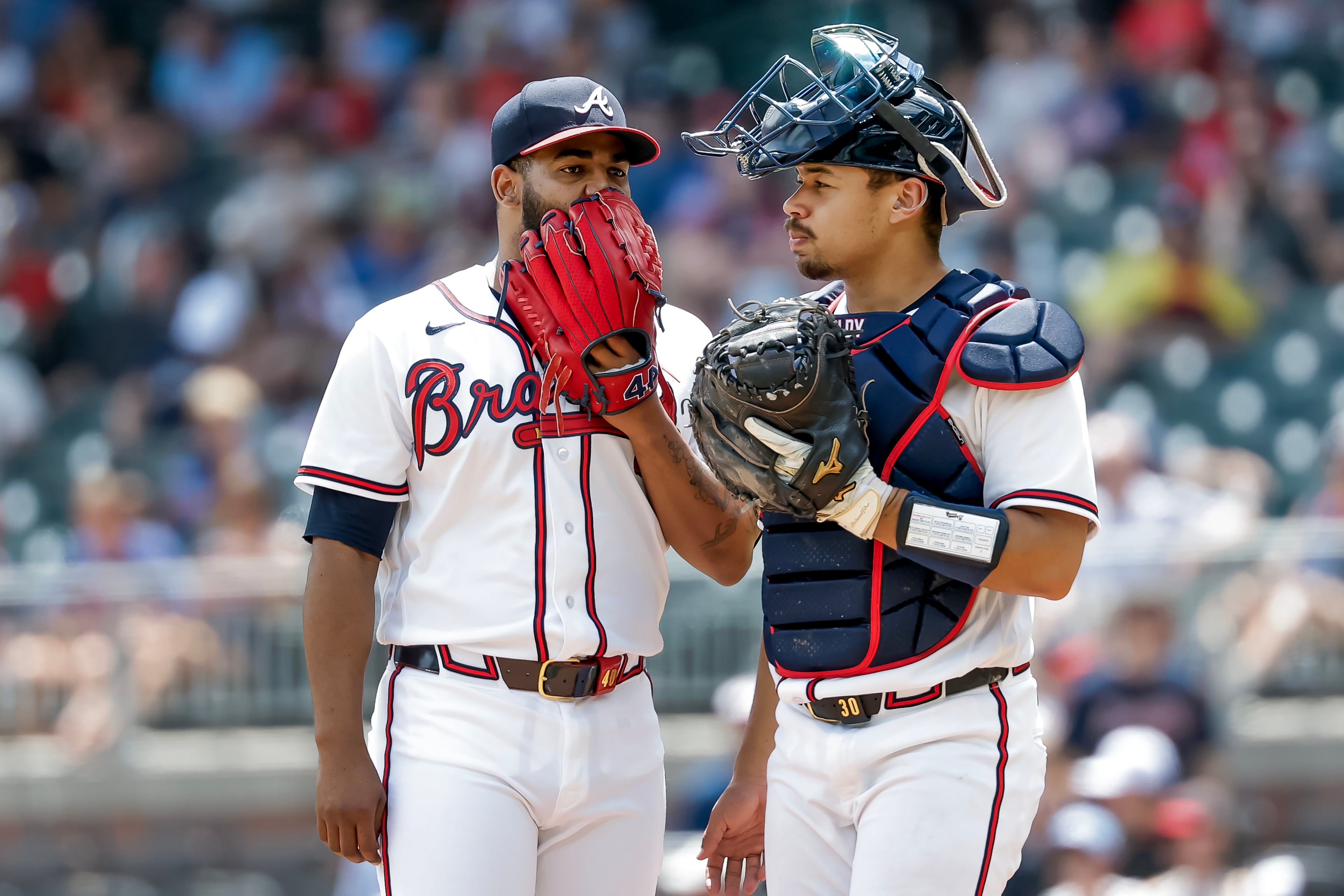 Reynaldo Lopez (left) hashes things out with catcher Drake Baldwin during a recent relief appearance. (Erik S. Lesser/AP)