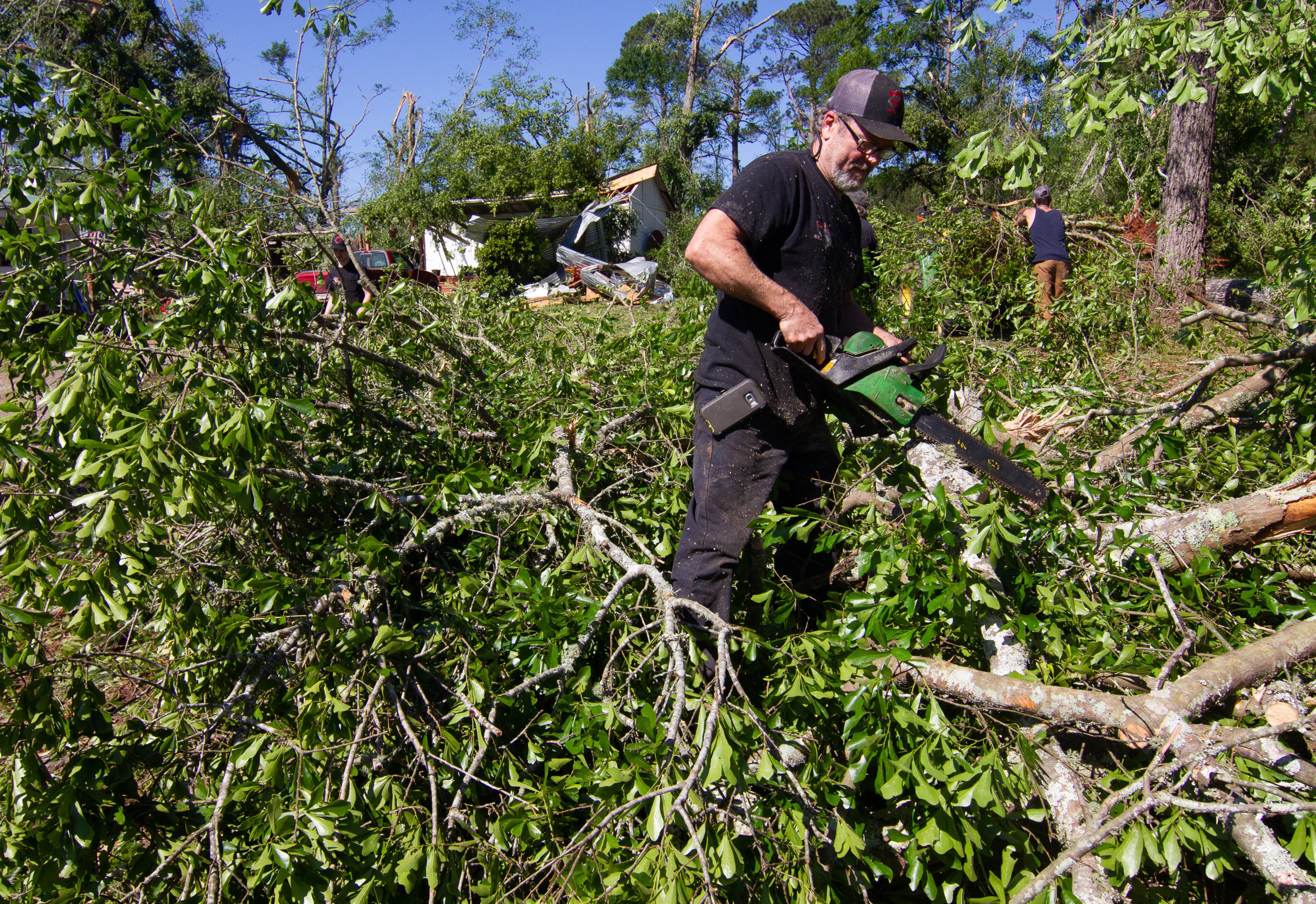 Paul Lewis helps to clear downed trees after a tornado damaged homes and property along Trinity Road in Thomaston, GA. Monday, April 13, 2020. STEVE SCHAEFER / SPECIAL TO THE AJC