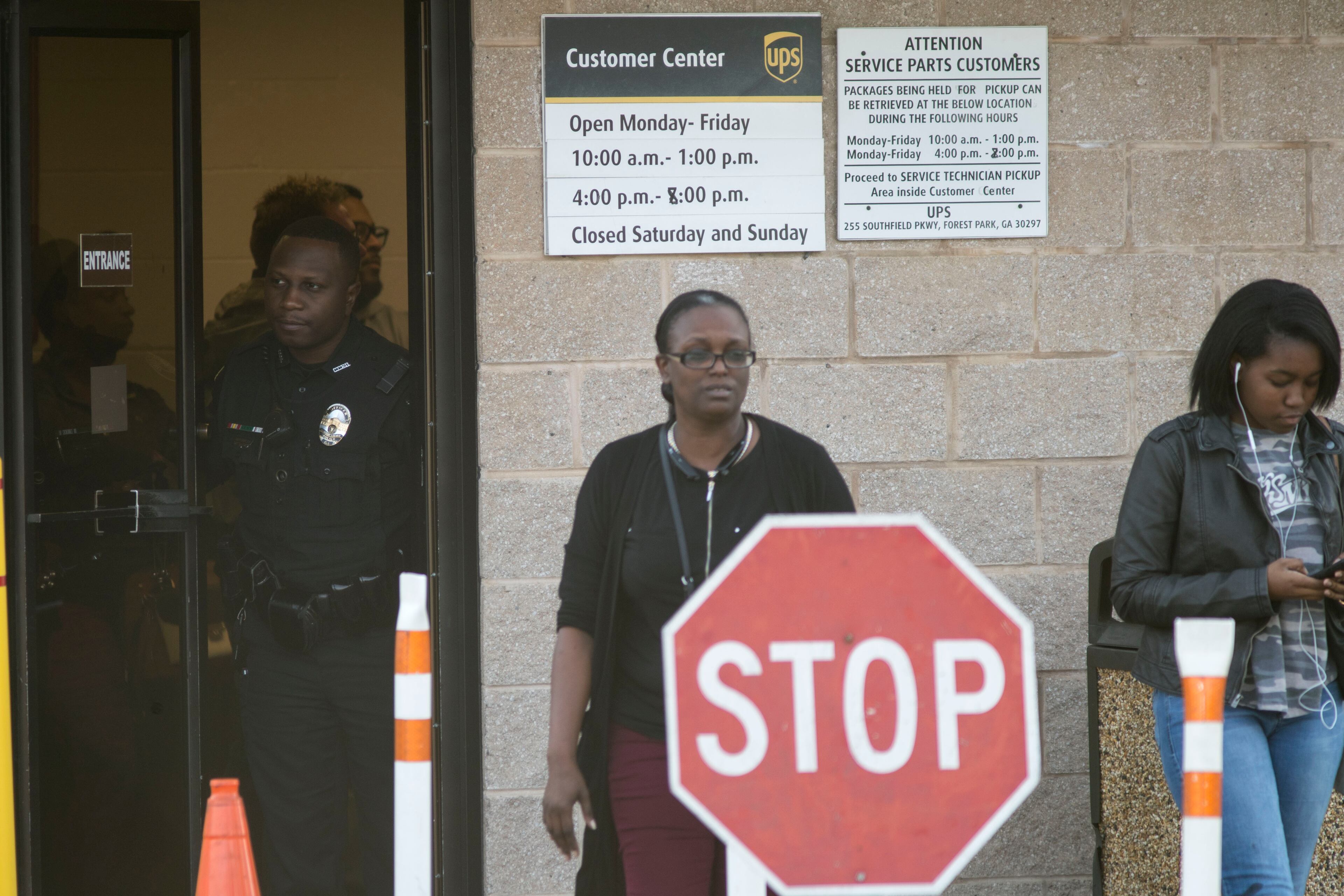 12/26/2017 -- Forest Park, GA, - A Clayton County police officer turns away pedestrians at the entrance of the UPS customer center in Forest Park, Tuesday, December 26, 2017. The officer informed customers that the customer center would not be accepting any more business around 2:50 Tuesday afternoon. The center stayed open a couple hours after its regular closing time to assist customers who had not received their orders before the Christmas holiday. ALYSSA POINTER/ALYSSA.POINTER@AJC.COM