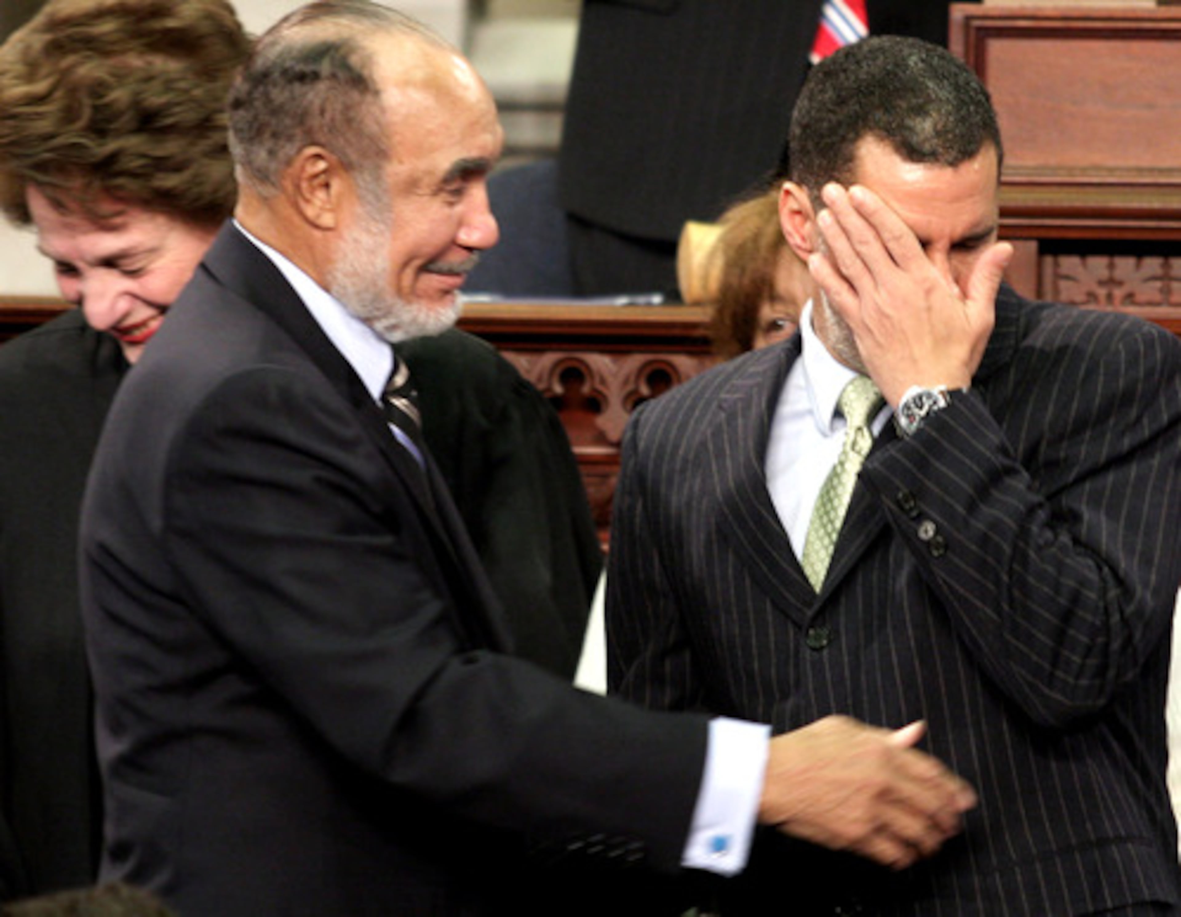 David Paterson, New York's new governor, wipes a tear from his face as he is congratulated by his father Basil Paterson, a former New York senator.