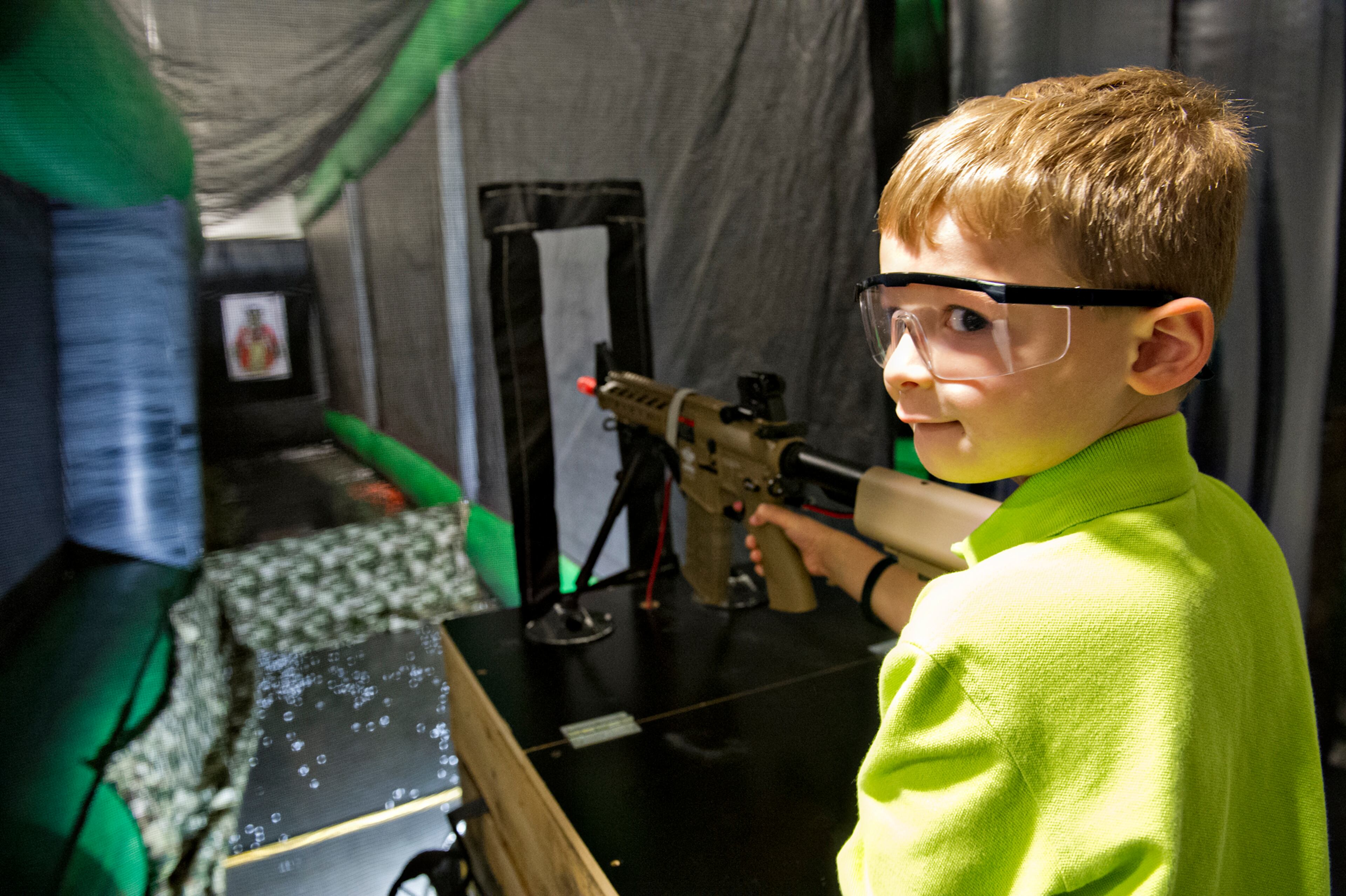 Cash Canter glances over his shoulder as he fires a pellet gun during Walker Stalker Con in Atlanta on Sunday, Oct. 19, 2014. For three days fans got the chance to immerse themselves in all things Walking Dead and zombies. JONATHAN PHILLIPS / SPECIAL