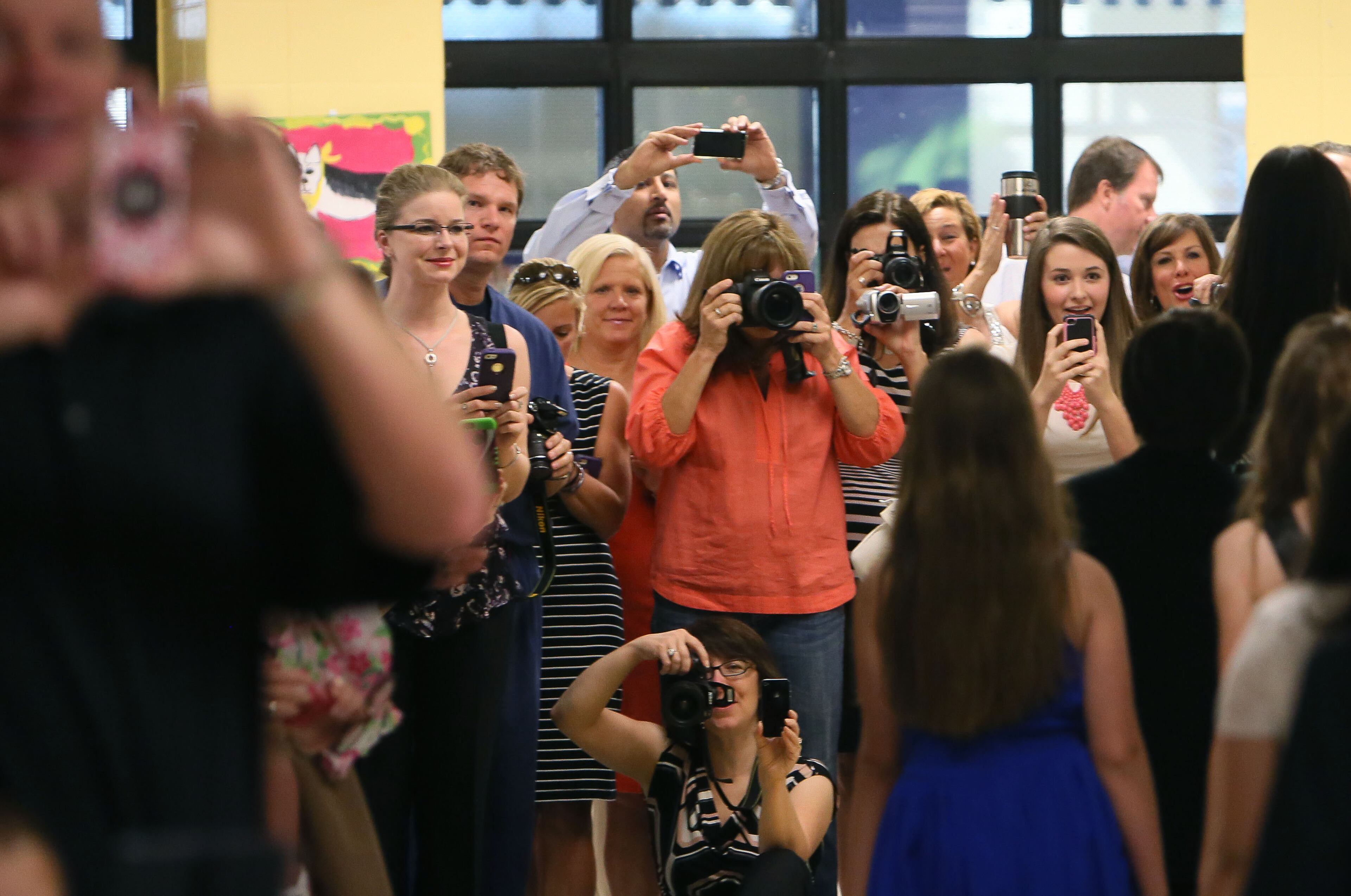 Family members line up at the end of the main hallway to watch the parade of fifth graders. Fulton County's Summit Hill Elementary School, in Alpharetta, held a celebration for it's departing fifth graders that included a parade through the halls and a celebration ceremony. Thursday was the last day of school in Fulton, Cobb and other districts. BOB ANDRES / BANDRES@AJC.COM