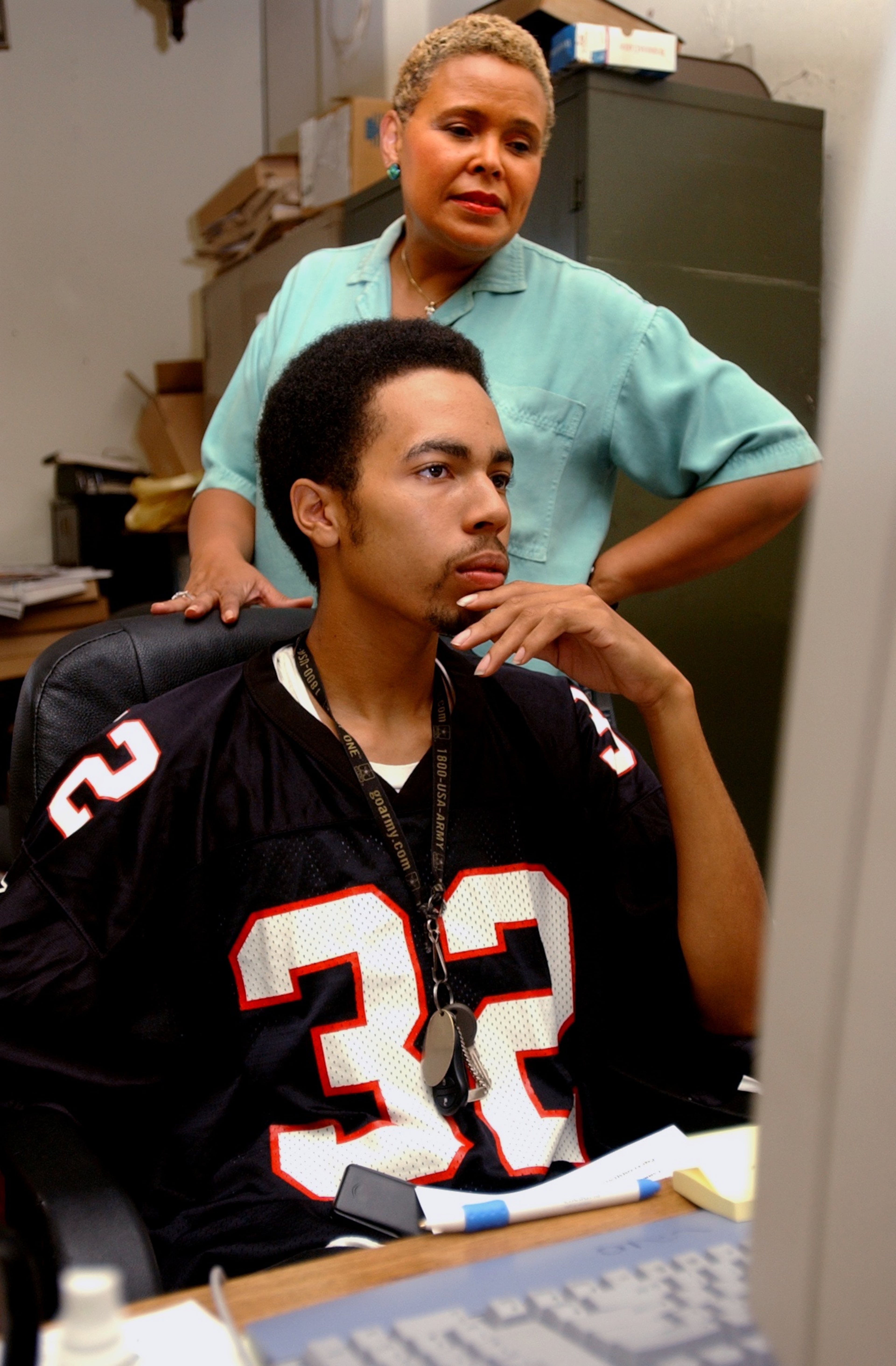 Alexis Scott, publisher of Atlanta Daily World, as the paper was about to celebrate its 75th anniversary. She is looking over the shoulder of her nephew Kai Scott, a layout and web assistant, as he works on the upcoming front page. Photo is from Sept. 16, 2003 (Renee' Hannans/Staff).