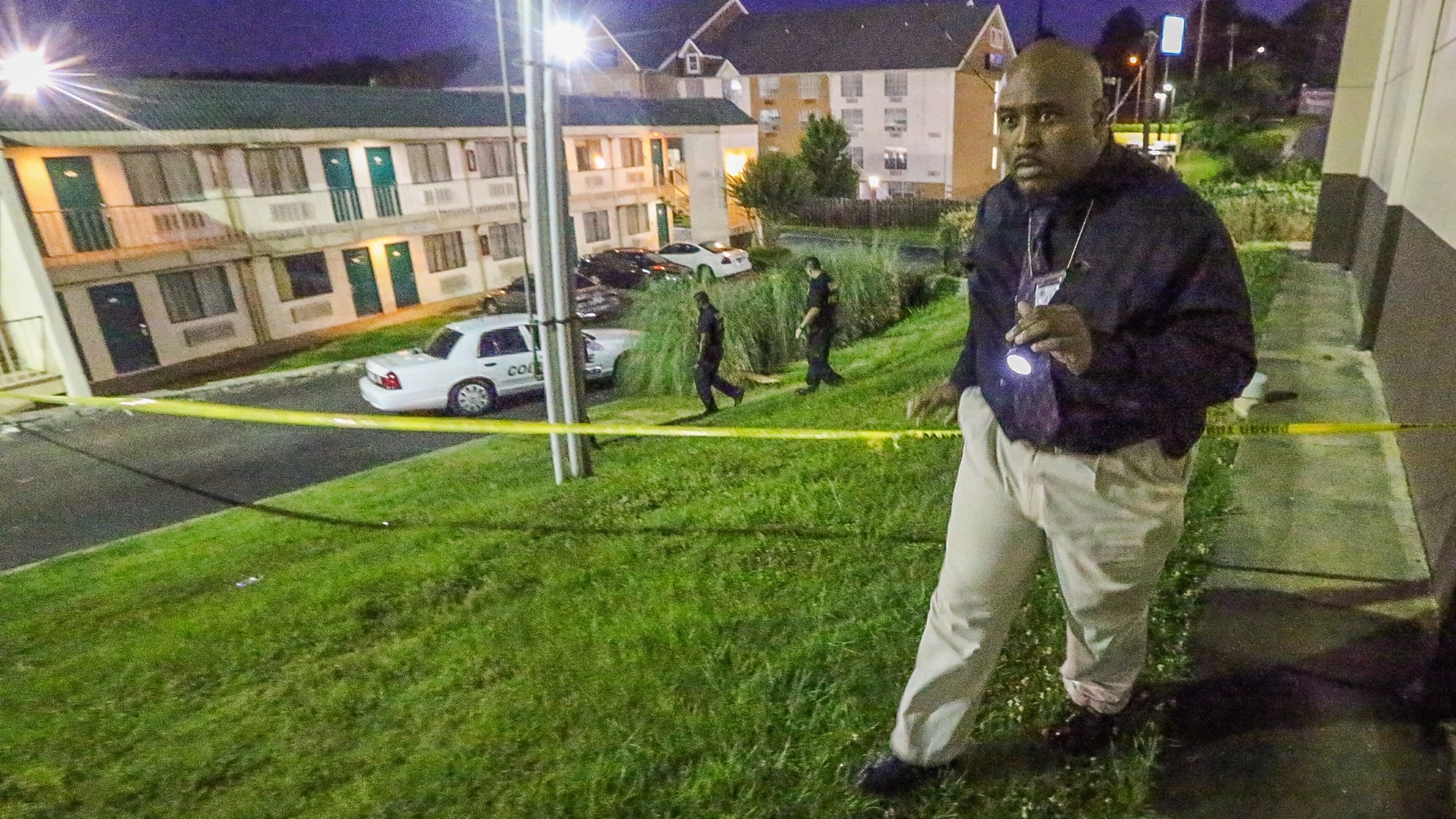 Authorities investigate a fatal shooting at the Masters Inn on Windy Hill Road continued early Thurs., June 18, 2015. JOHN SPINK / JSPINK@AJC.COM