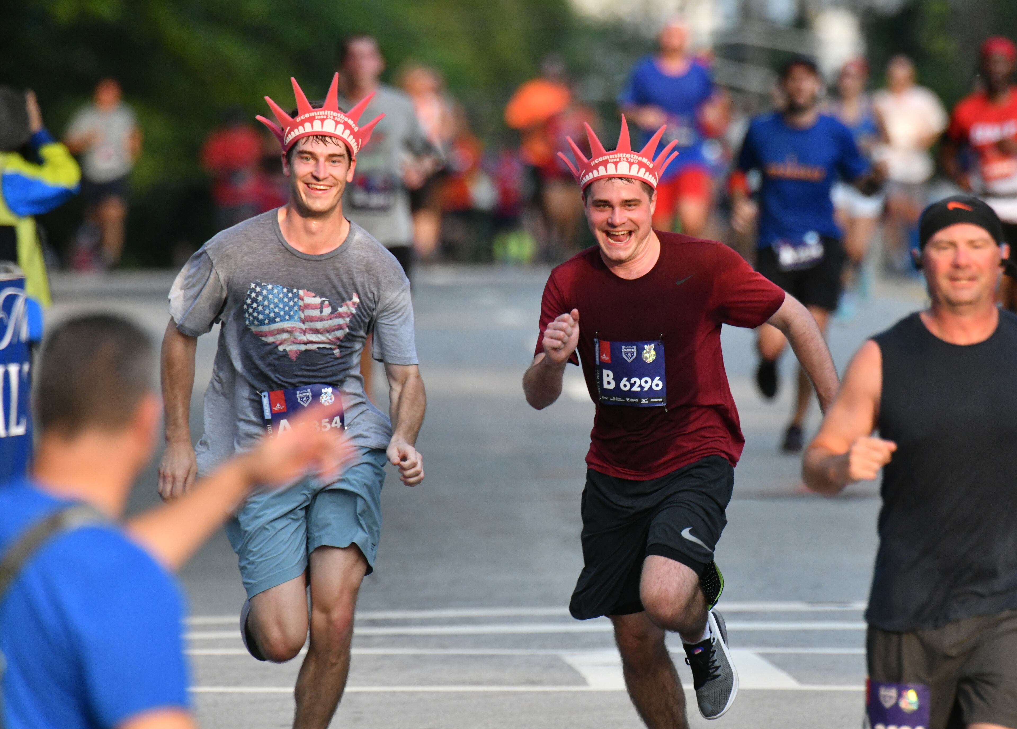 July 3, 2021 Atlanta - Runners make their way to the finish line during the first day of 2021 Atlanta Journal-Constitution Peachtree Road Race on Saturday, July 3, 2021. (Hyosub Shin / Hyosub.Shin@ajc.com)