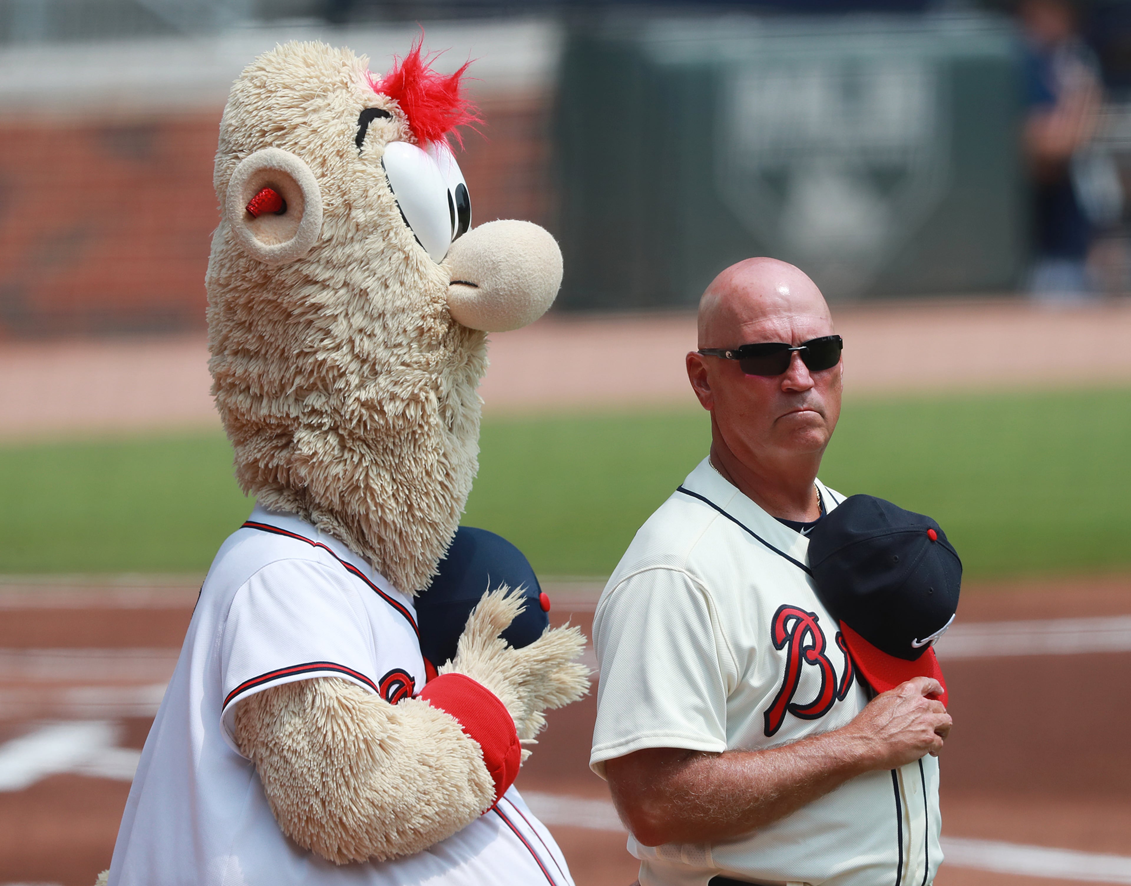 Braves manager Brian Snitker and team mascot Blooper stand during the National Anthem before playing the Miami Marlins on August 13, 2018, in Atlanta. Curtis Compton/ccompton@ajc.com
