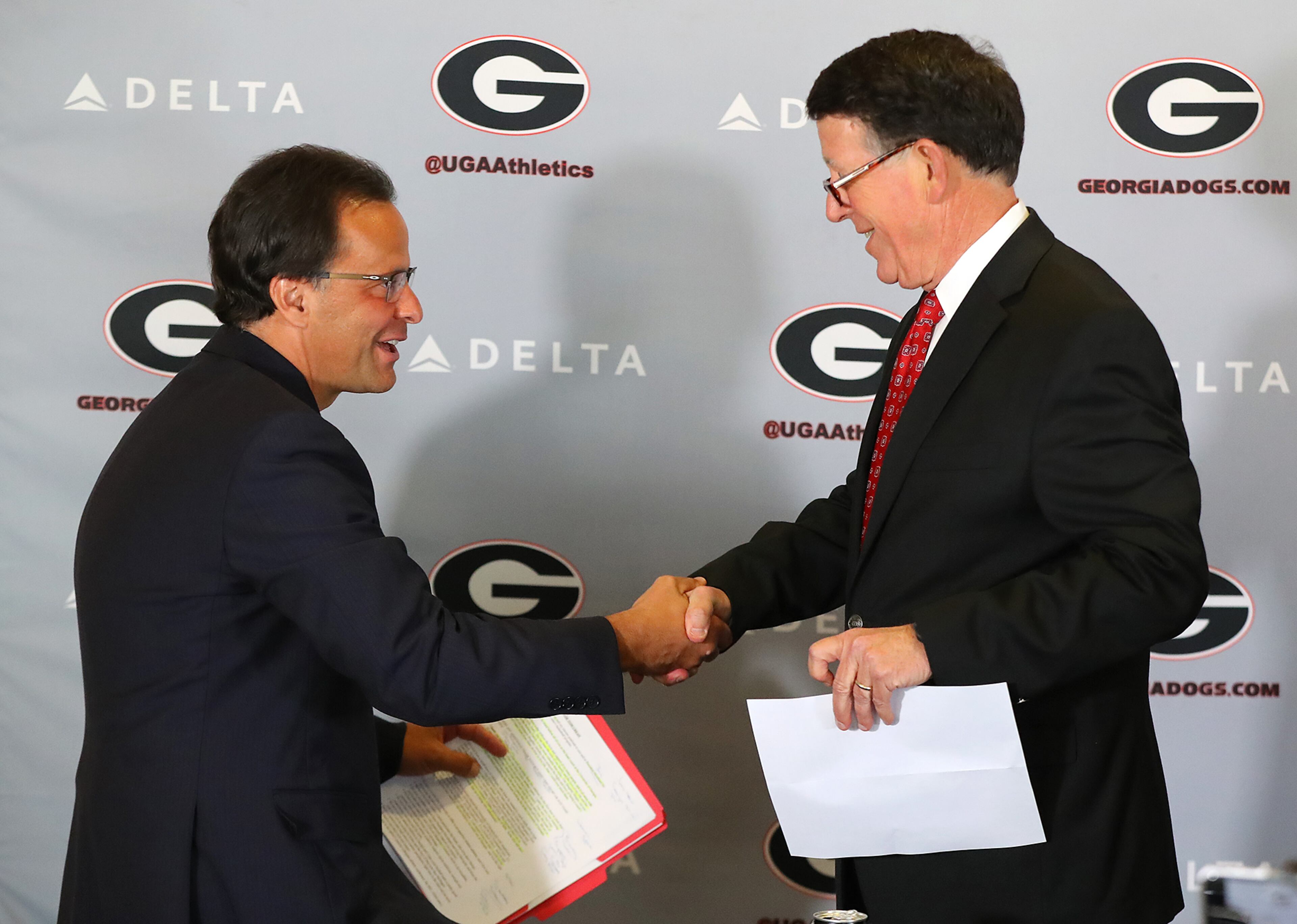 March 16, 2018 Athens: Georgia athletics director Greg McGarity (right) introduces Tom Crean as the new men's basketball head coach at the University of Georgia on Friday, March 16, 2018, at Stegeman Coliseum in Athens. Crean compiled a 356-231 record in 18 seasons at Marquette and Indiana from 1999-2017. Curtis Compton/ccompton@ajc.com