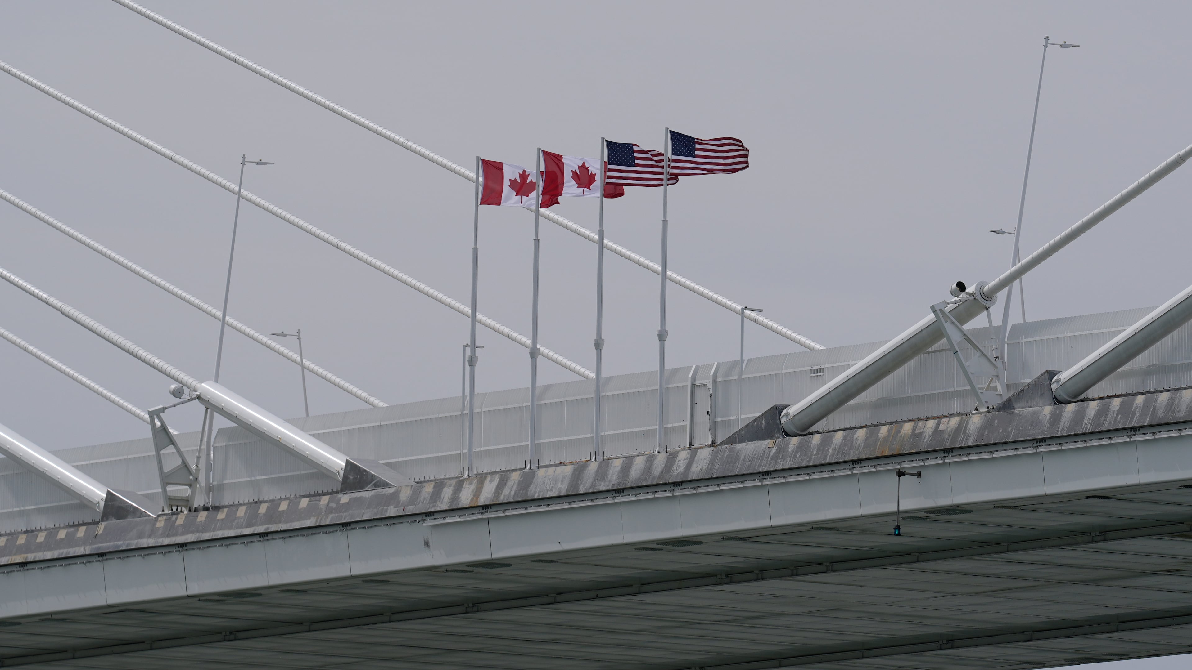 FILE - Canadian and American flags are shown on the Gordie Howe Bridge under construction between Windsor, Ontario and Detroit, May 22, 2026. (AP Photo/Paul Sancya, File)