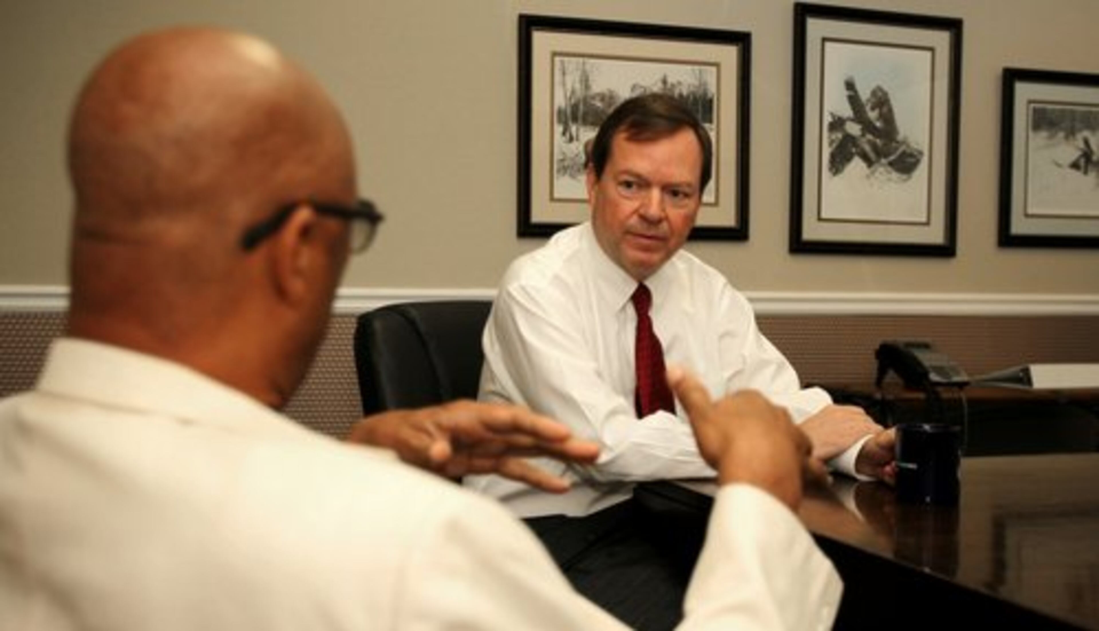 Craig Gillen (right), an attorney for Eddie Long, was interviewed on a radio program on Thursday about the charges against his client. Here, he confers with attorney Dwight Thomas.