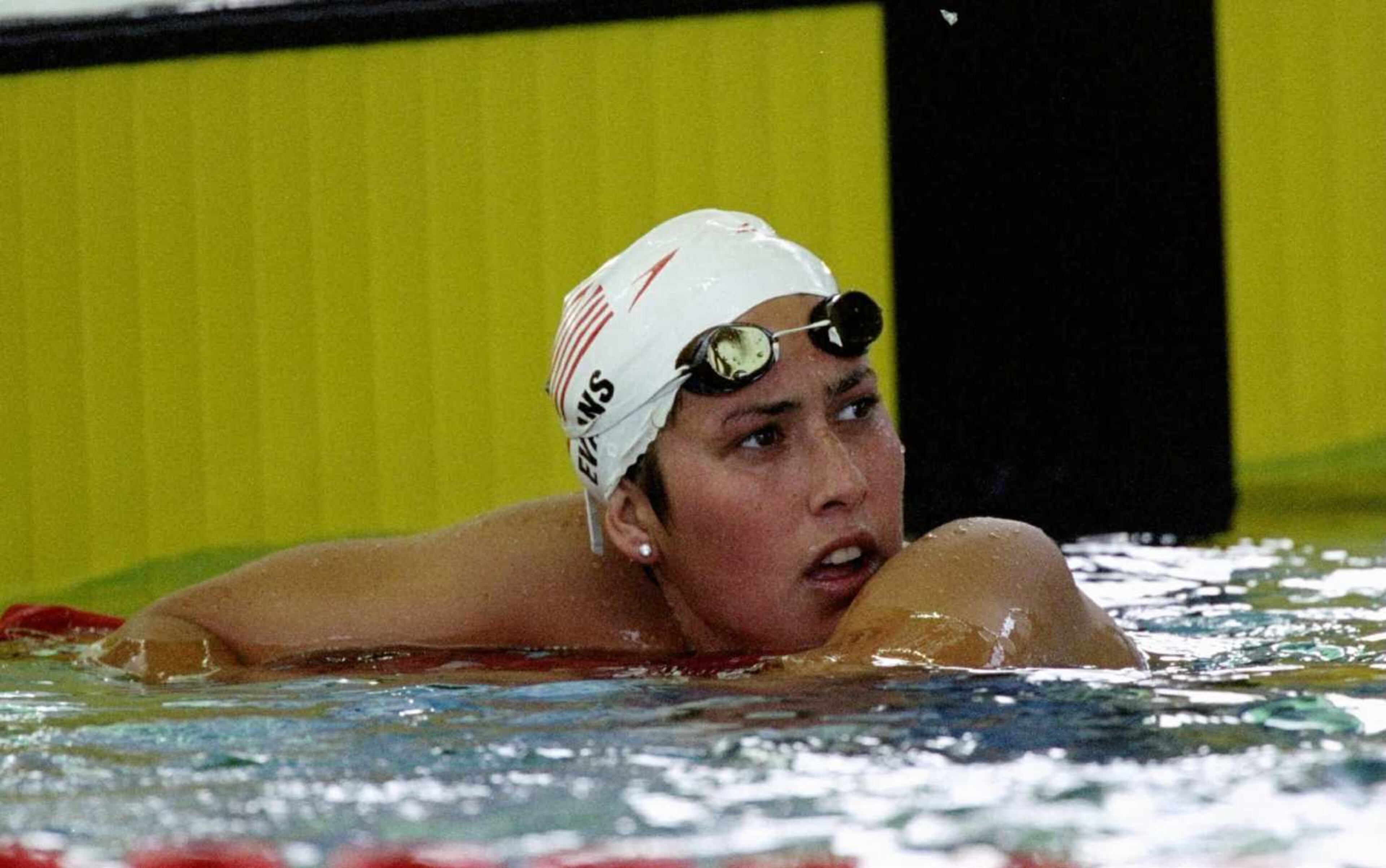 Janet Evans of the USA looks back at the scoreboard after finishing second in her heat in the women's 400-meter freestyle. (Special to the AJC/Jed Jacobsohn/Allsport)