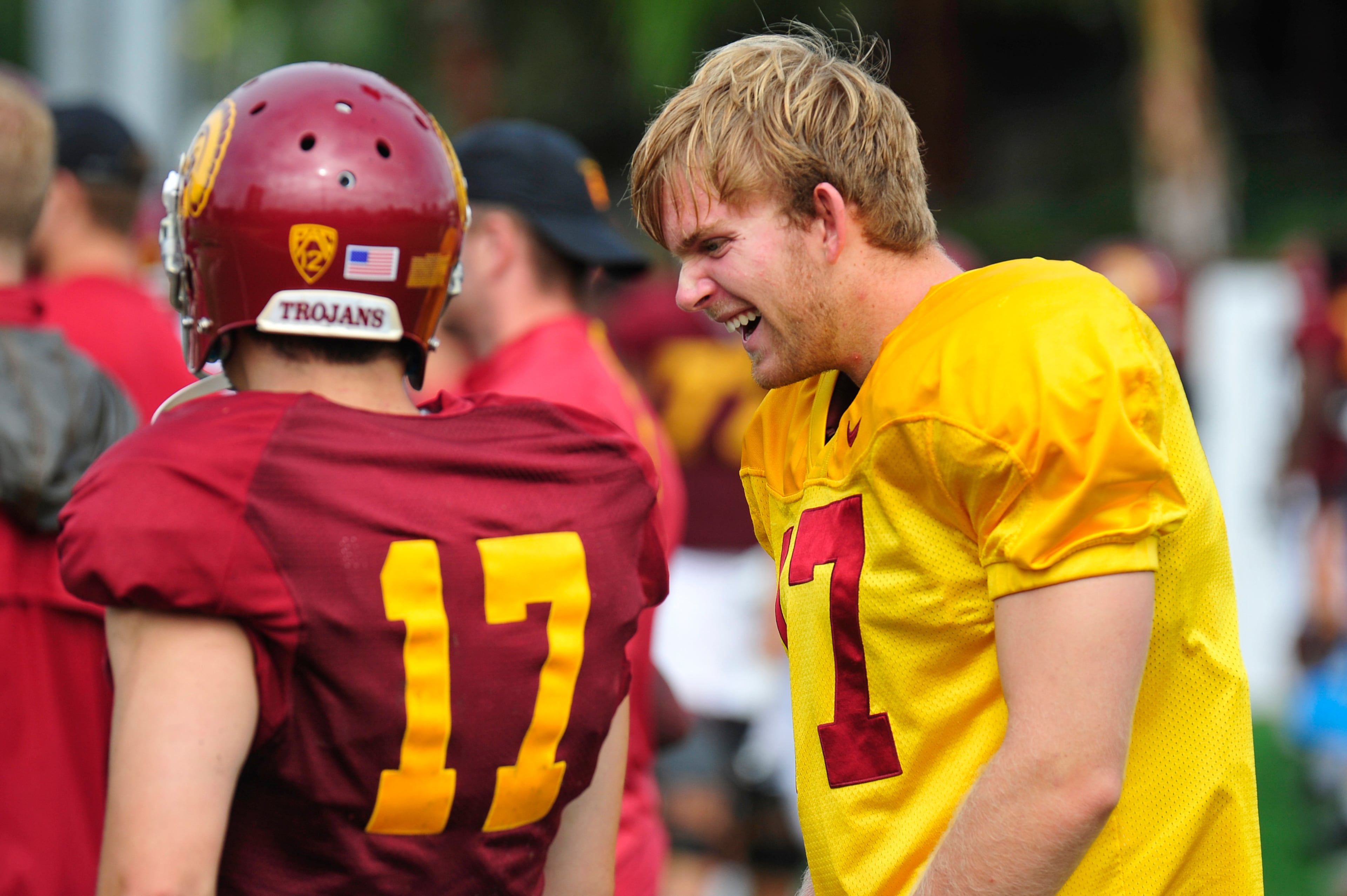 This photo provided by the University of Southern California shows USC football player Jake Olson, right, jokes around with a teammate during NCAA college football practice, Tuesday, Sept. 15, 2015, in Los Angeles. Olson who completely lost his sight six years ago still has a dream of playing football at Southern California. The blind long-snapper is one step closer to the Coliseum after practicing with the Trojans on Tuesday. (John McGillen/USCTrojans.com via AP)