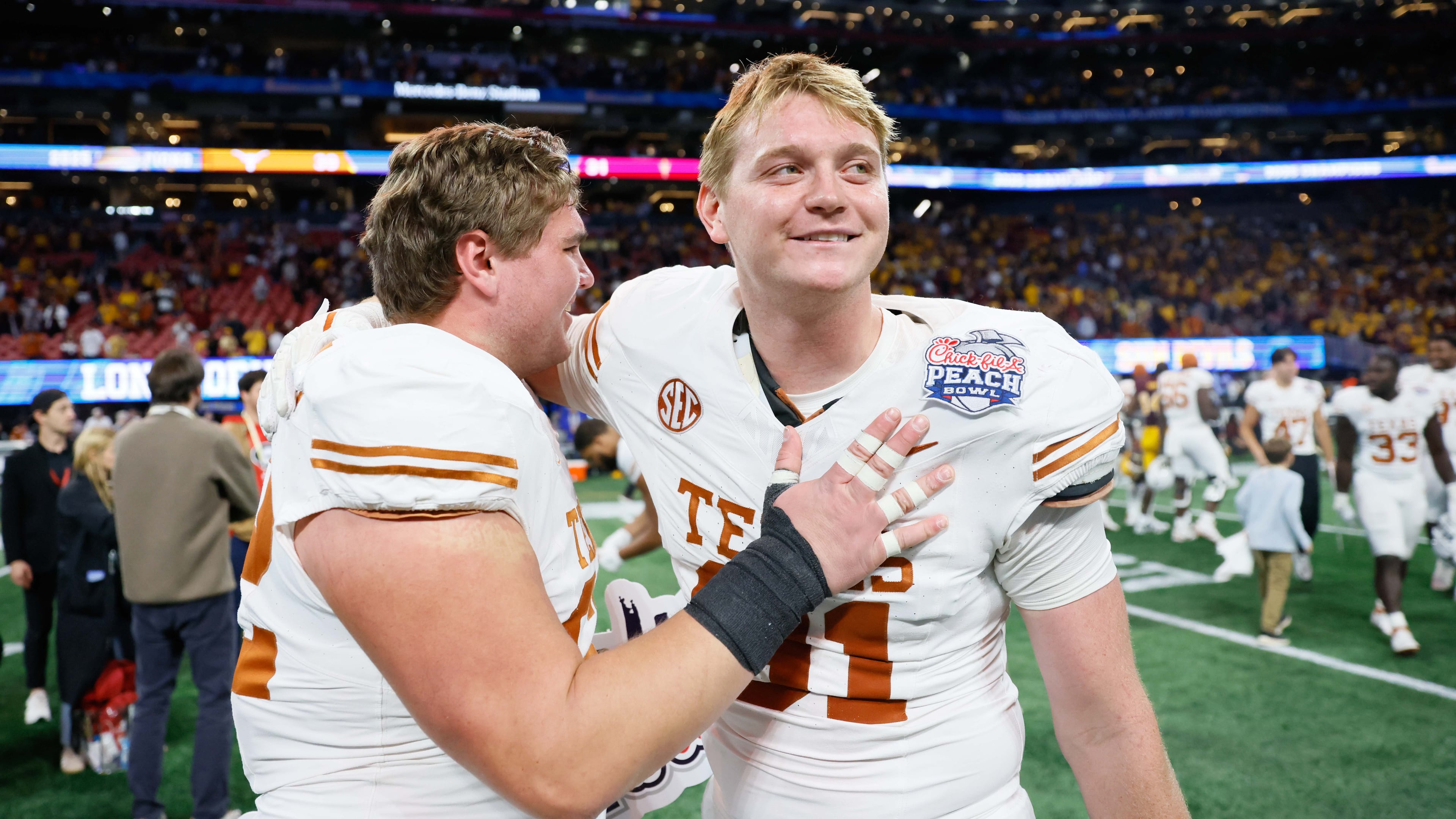 Texas Longhorns players celebrate after defeating the Arizona State Sun Devils 39-31 in double overtime at the Chick-fil-A Peach Bowl held at Mercedes-Benz Stadium on Wednesday, January 1, 2025, in Atlanta.
(Miguel Martinez / AJC)