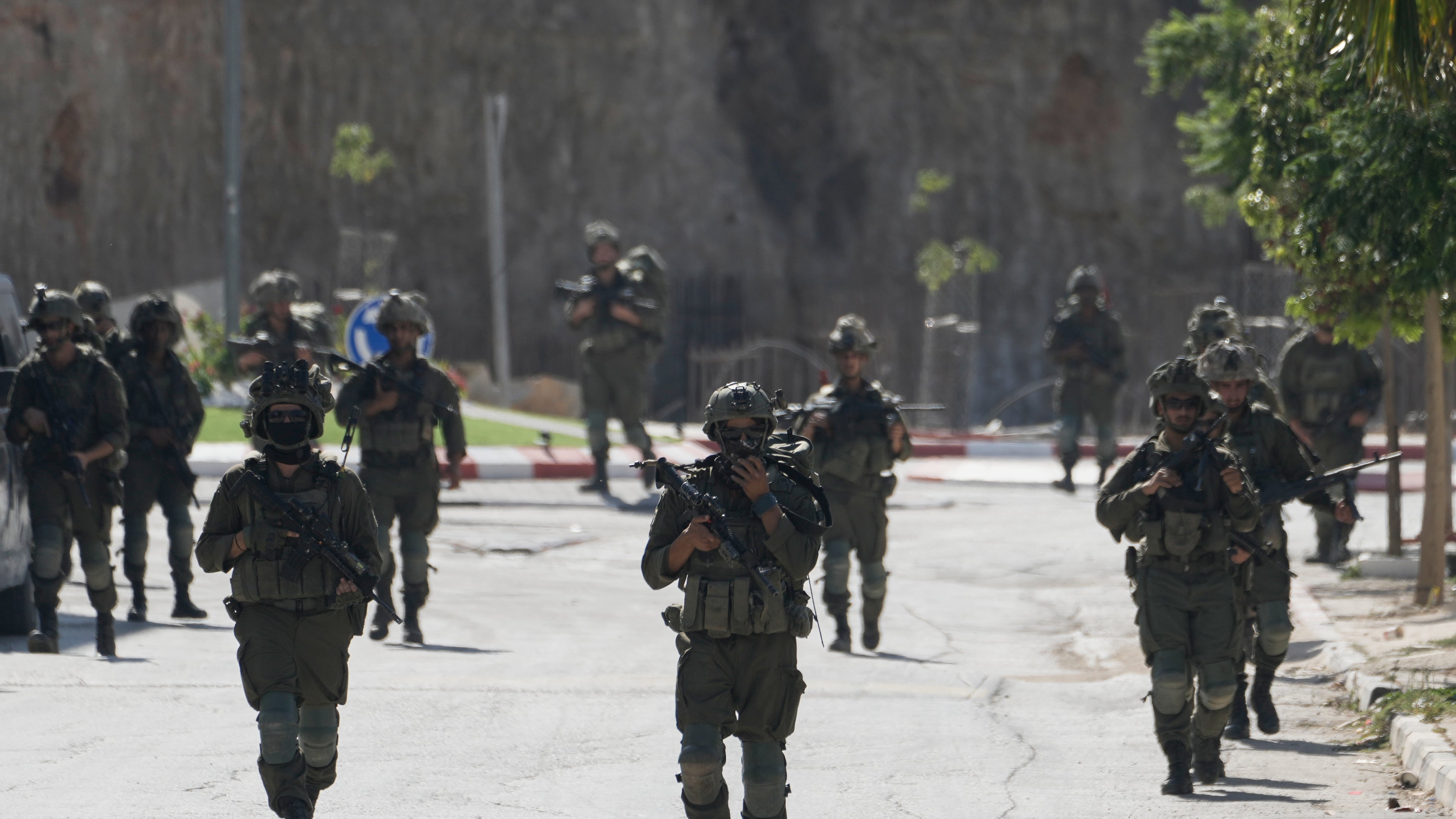 Israeli army soldiers patrol the streets of the occupied West Bank village of Qusra, south of Nablus, Thursday, Aug. 13, 2026. (AP Photo/Majdi Mohammed)
