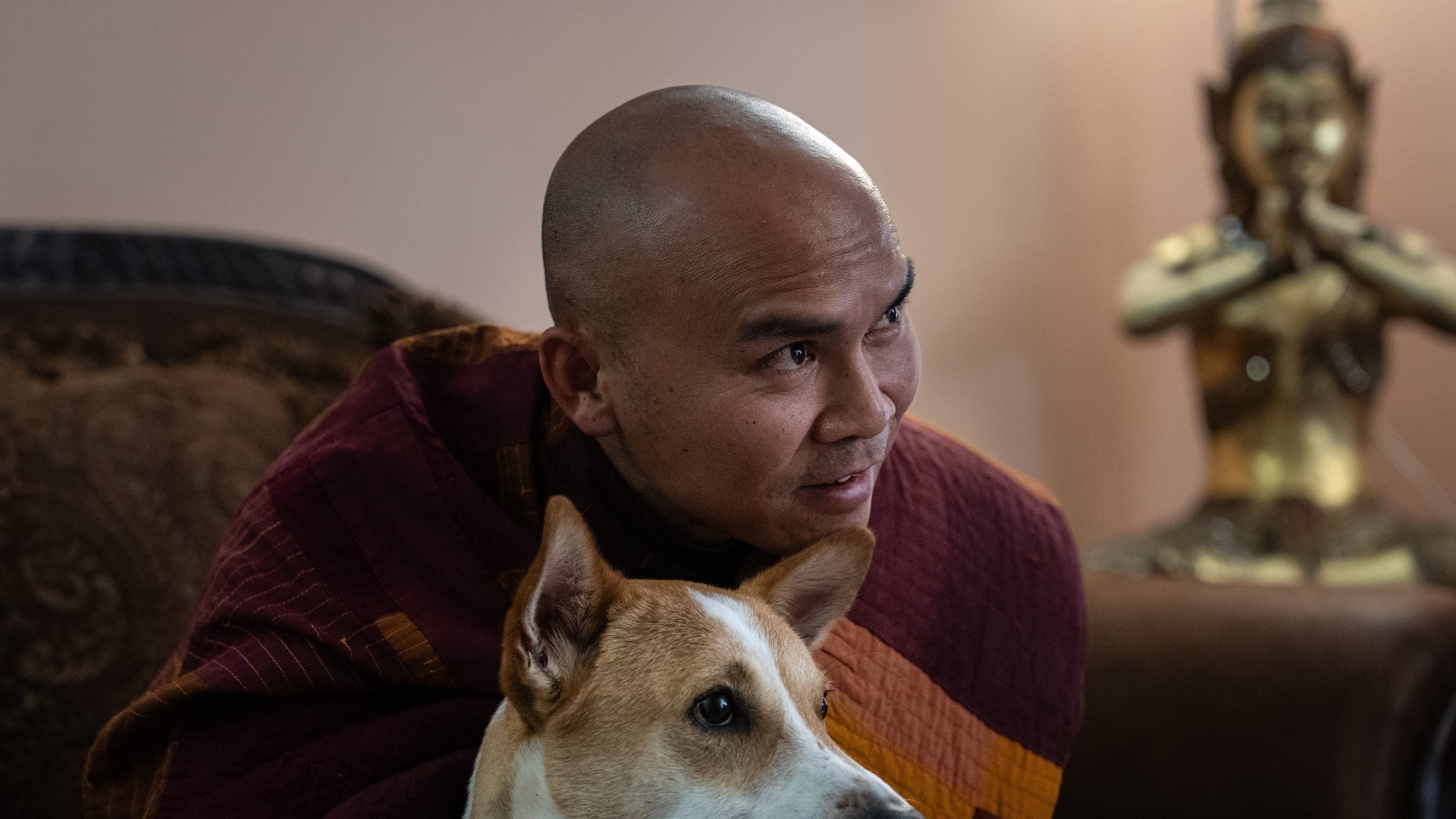 Bhikkhu Pannakara, a Buddhist monk who led a Walk for Peace from Fort Worth, Texas, to Washington, D.C., sits with his dog, Aloka, before an event at Wat Thai of Los Angeles in the North Hollywood section of Los Angeles, Monday, July 13, 2026. (AP Photo/Jae C. Hong)