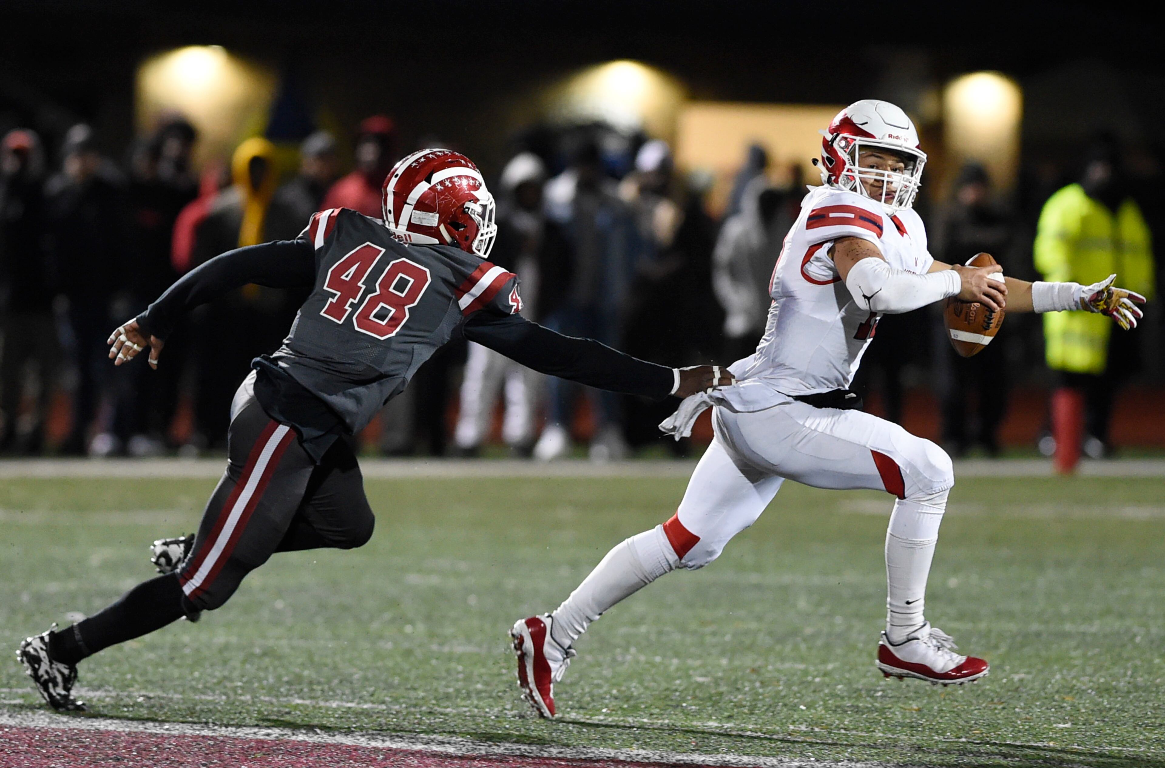 Hillgrove's Chase Rivers, left, grabs Milton's Jordan Yates during the second half of the playoff game, Friday, Nov. 23, 2018, in Powder Springs, Georgia. (Annie Rice/AJC)
