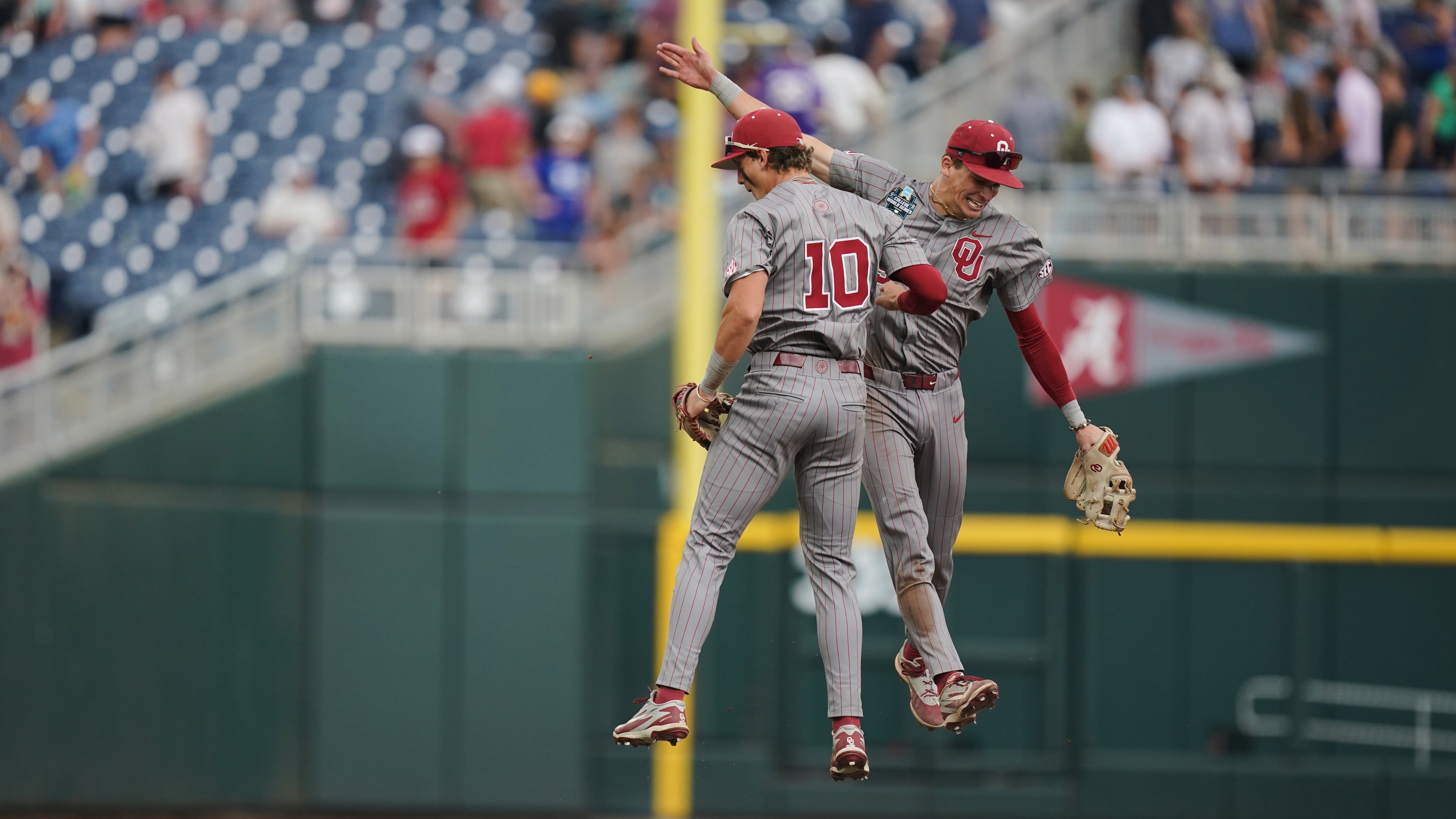 Oklahoma catcher Brendan Brock (10) and infielder Kyle Branch (6) celebrate after an NCAA baseball College World Series game, Saturday, June 13, 2026 in Omaha, Neb. Oklahoma won 9-0. (AP Photo/Vera Nieuwenhuis)
