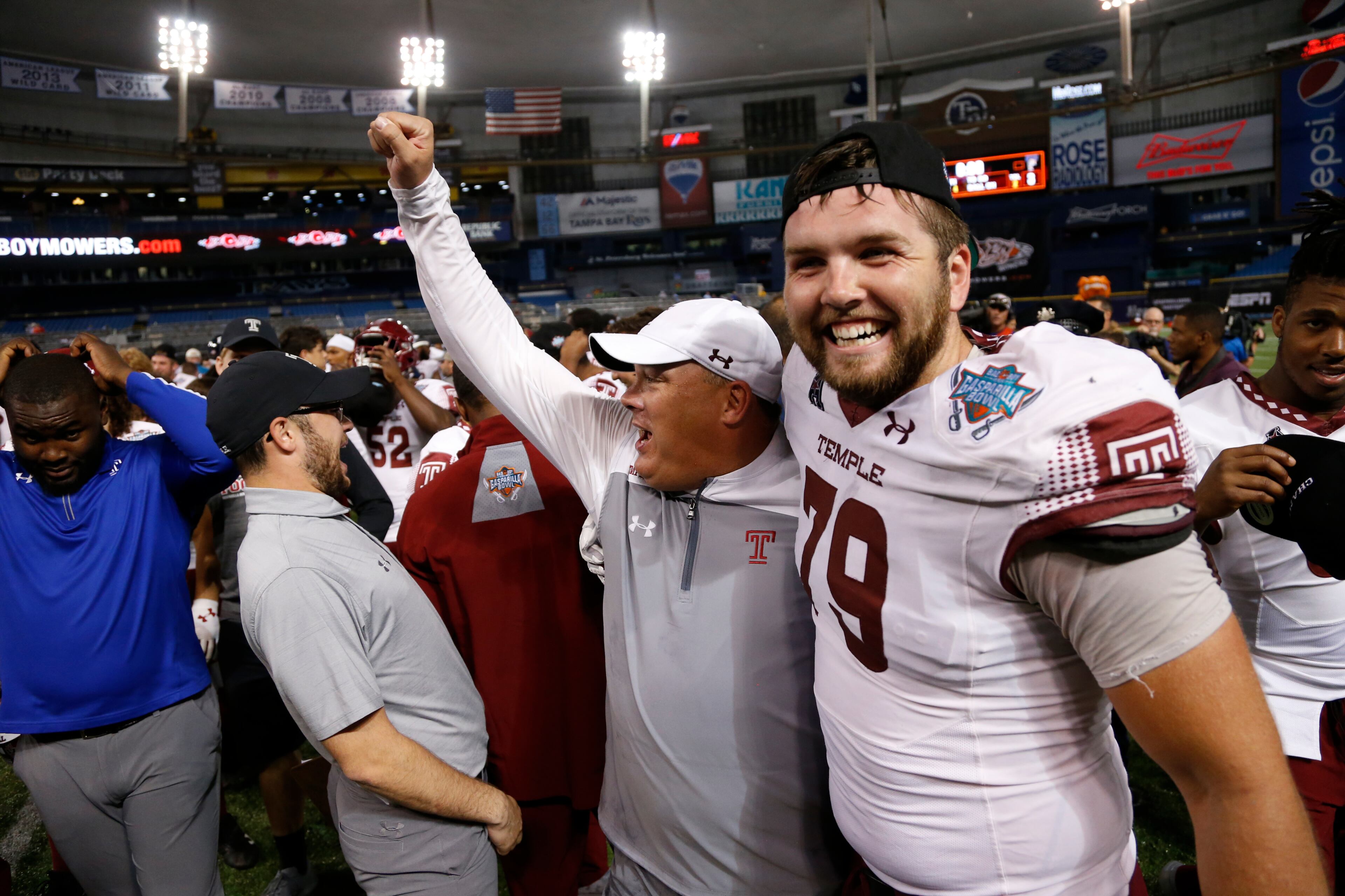 ST. PETERSBURG, FL - DECEMBER 21: Head coach Geoff Collins of the Temple Owls celebrates with offensive lineman Cole Boozer #79 following their 28-3 win over the Fiu Golden Panthers at the Bad Boy Mowers Gasparilla Bowl on December 21, 2017 at Tropicana Field in St. Petersburg, Florida. (Photo by Brian Blanco/Getty Images)