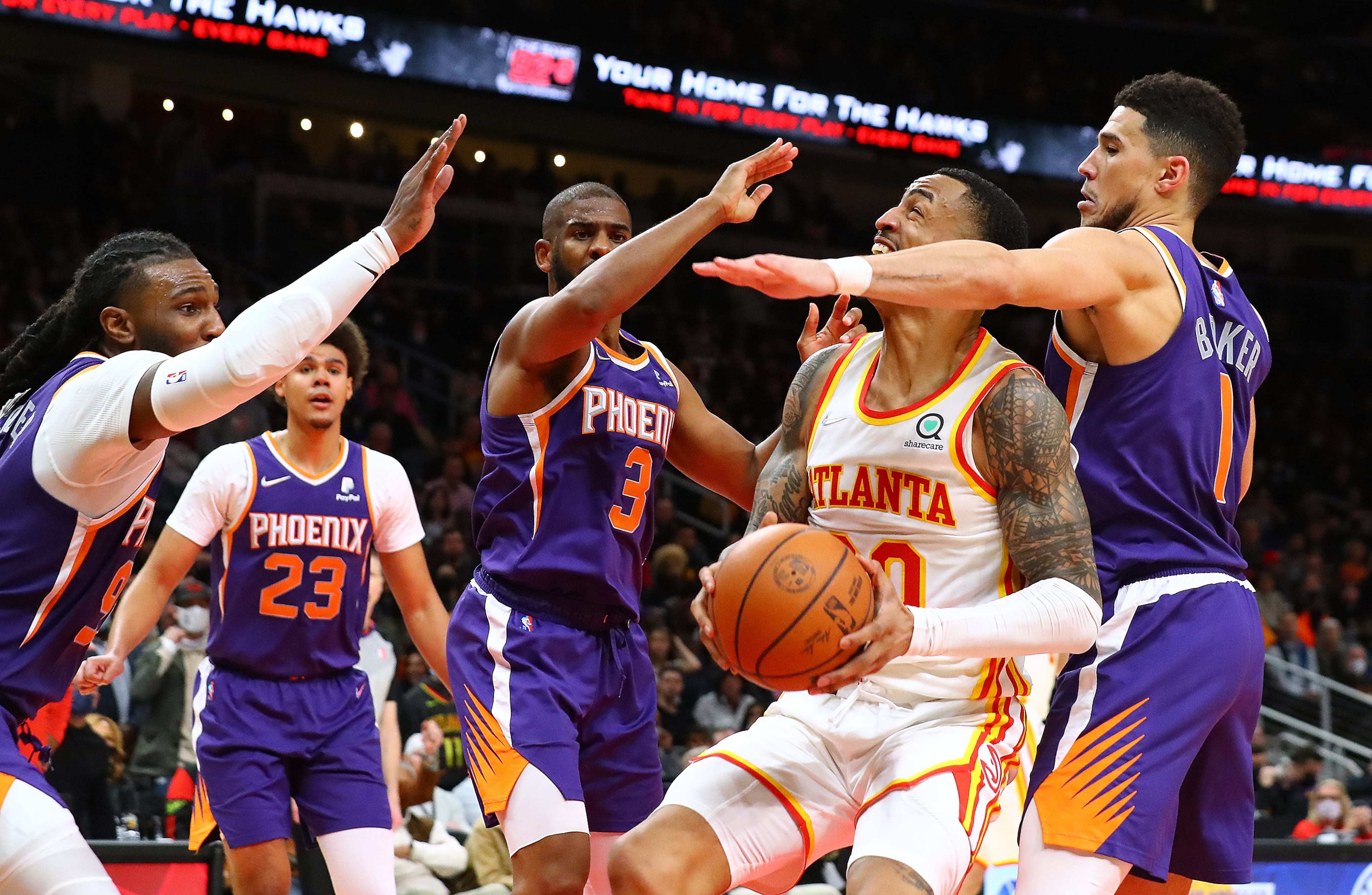 Hawks forward John Collins, who appeared to injure himself on this play, goes to the basket for two against four Phoenix Suns defenders during a 124-115 victory in a NBA basketball game on Thursday, Feb. 3, 2022, in Atlanta. “Curtis Compton / Curtis.Compton@ajc.com”`