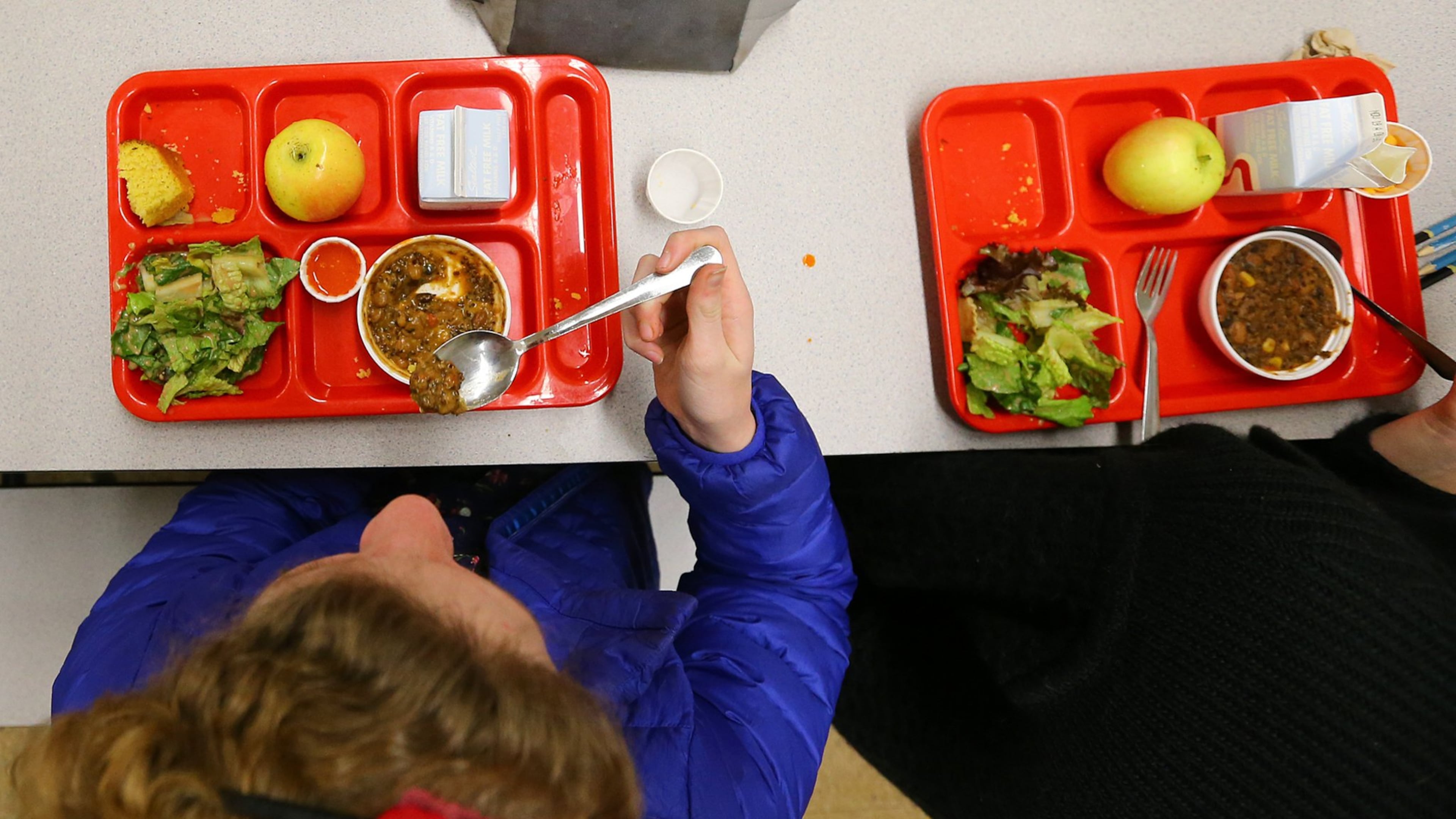 Students eat "veggie chili," cornbread, salad and an apple for lunch at an Atlanta charter school. Nearby City Schools of Decatur is struggling with $88,000 in unpaid meal debt. Starting in February, students who don't have the funds to pay for lunch will get a cheese sandwich and milk. (CURTIS COMPTON / CCOMPTON@AJC.COM)
