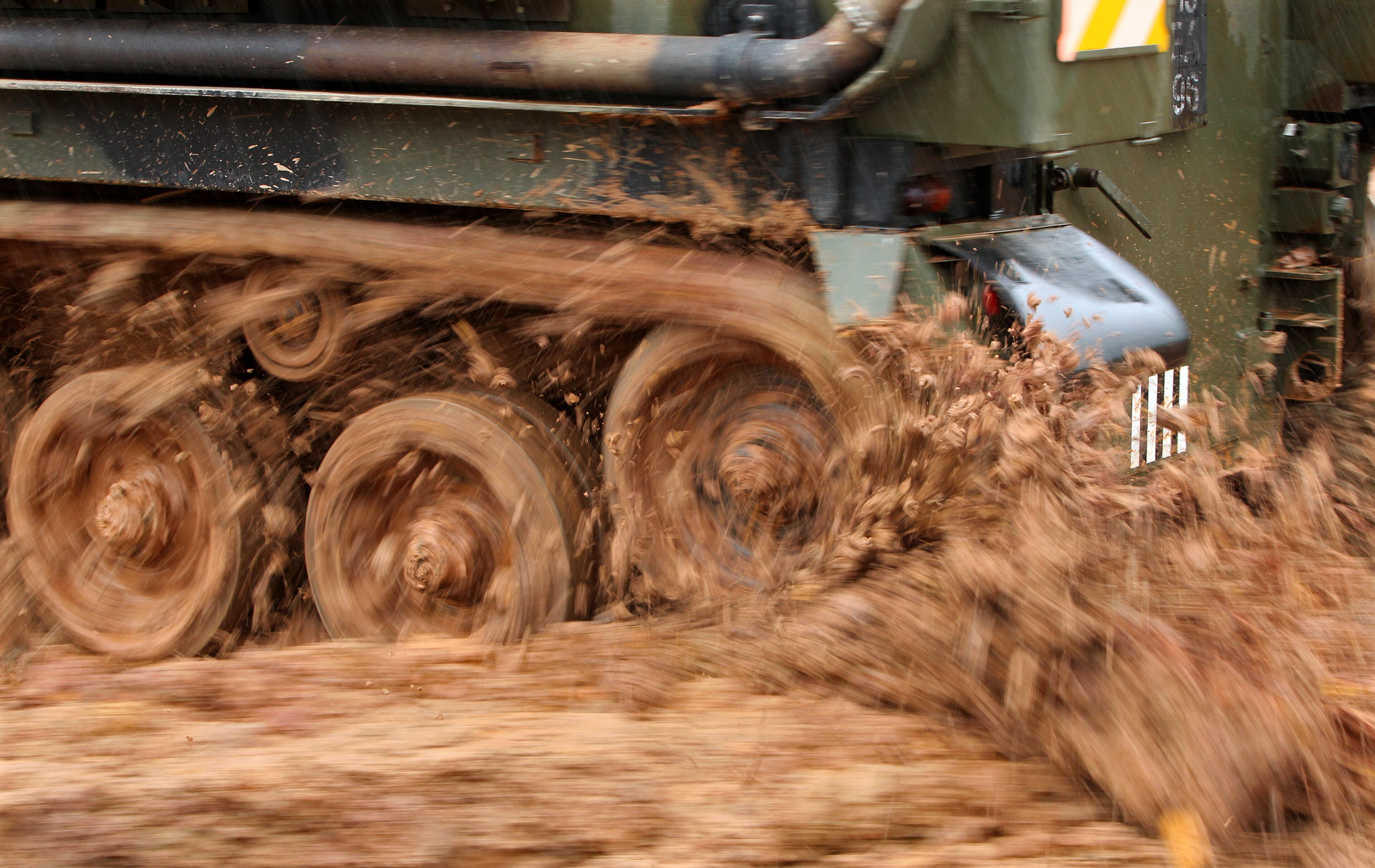 Rain and mud are no obstacle for the tracks of a tank while a customer navigates the course.
