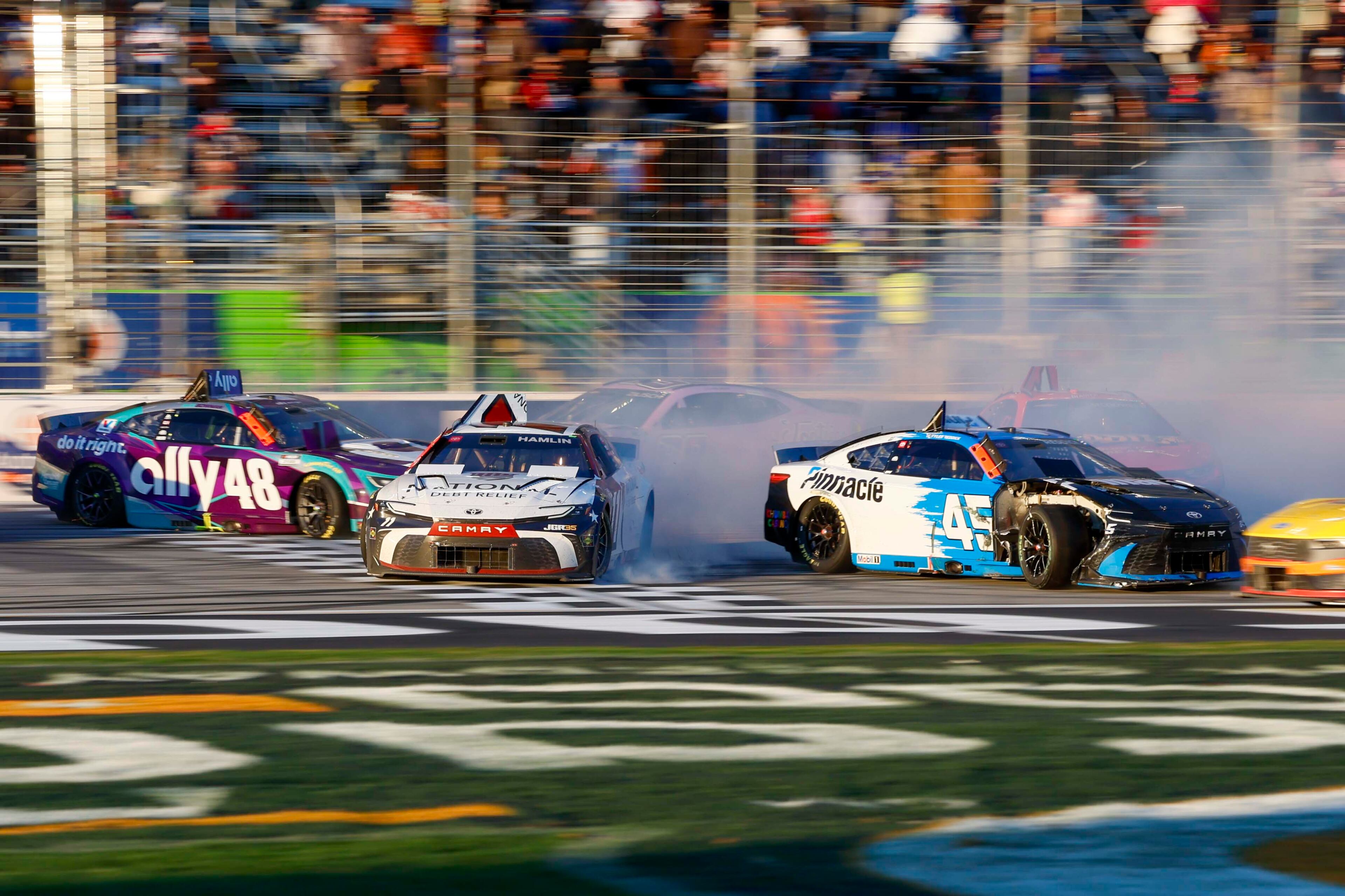 23XI Racing driver Tyler Reddick (45) spins with Joe Gibbs Racing driver Denny Hamlin (11) after a crash during the NASCAR Autotrader 400 race at EchoPark Speedway on Sunday, Feb. 22, 2026, in Hampton, Ga.
(Miguel Martinez/AJC)