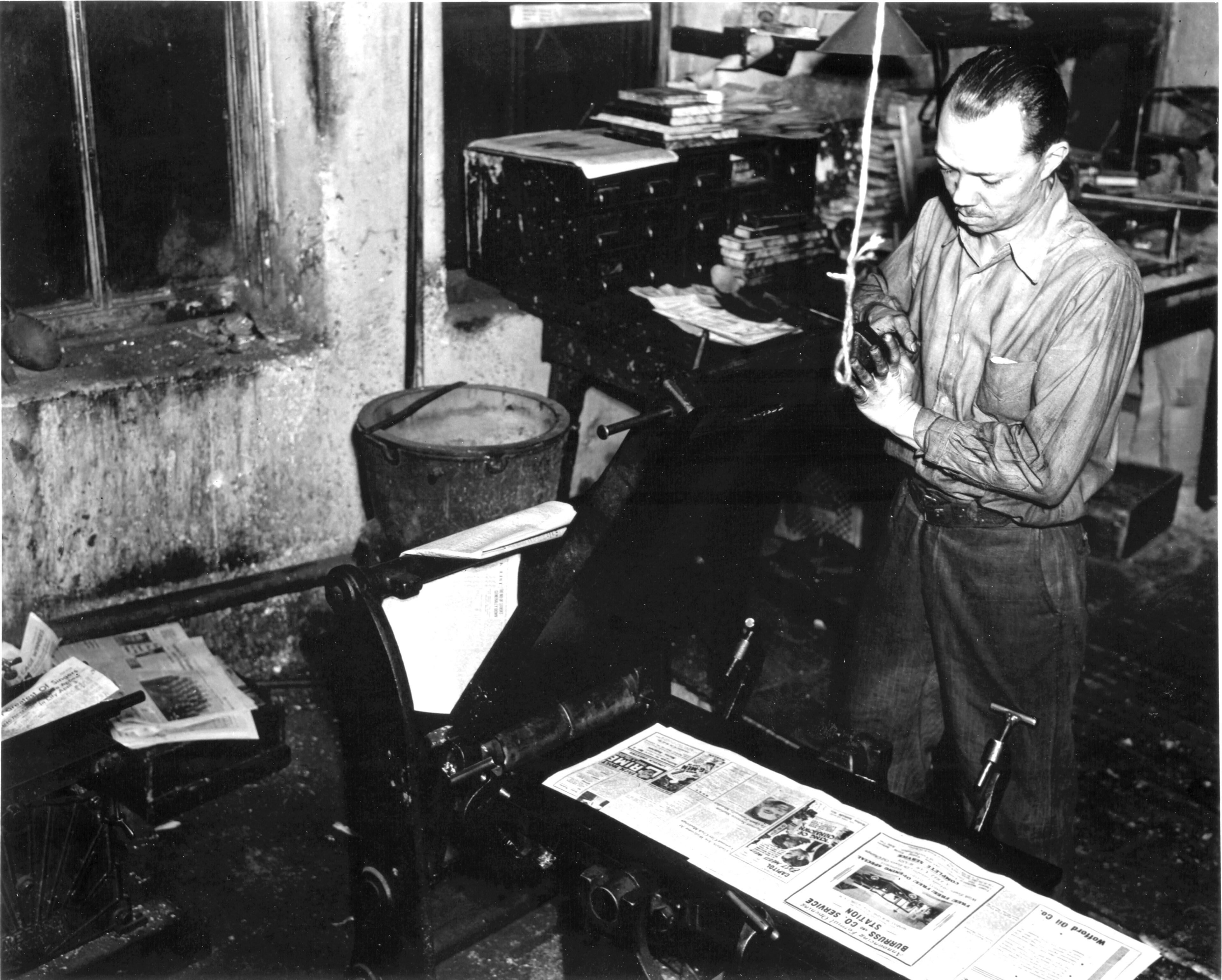 Undated 1940's photo of pressman (NO ID) in Atlanta Daily World printing plant from Atlanta Daily World archives