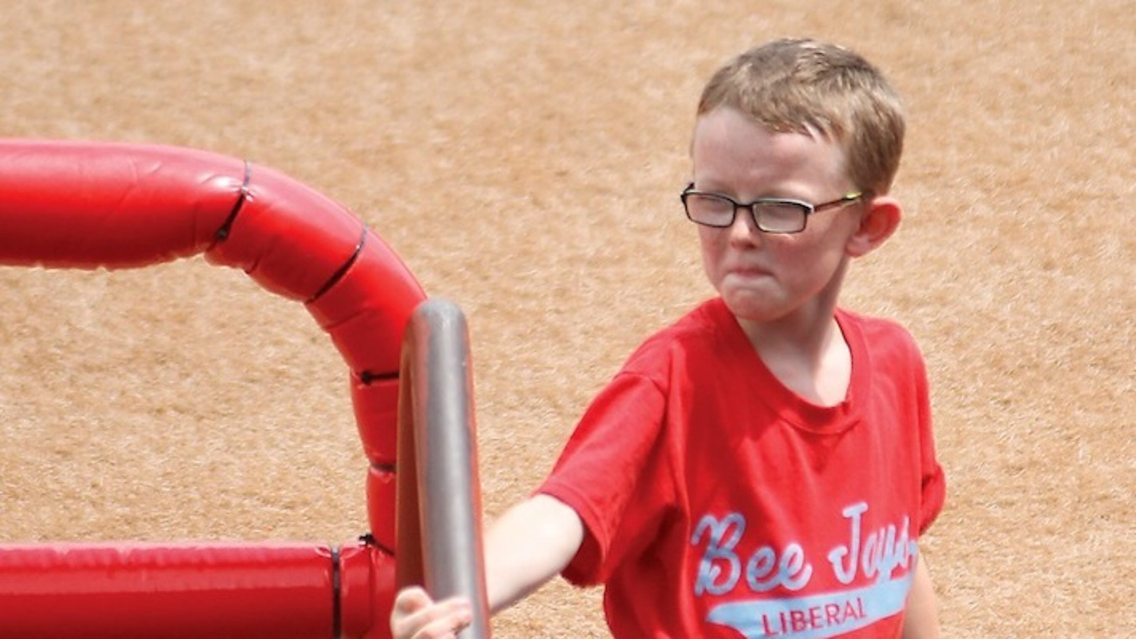 FILE - In this Aug. 1, 2015, file photo, bat boy Kaiser Carlile, 9, gets ready for a National Baseball Congress World Series baseball game between the Liberal Bee Jays and San Diego Waves outside the dugout in Wichita, Kan. The sale of a 1962 autographed World Series baseball has raised $30,000 for a memorial statue honoring Carlile, the batboy who died when he was accidentally hit by a bat during a game. (Earl Watt/Leader & Times via AP) MANDATORY CREDIT