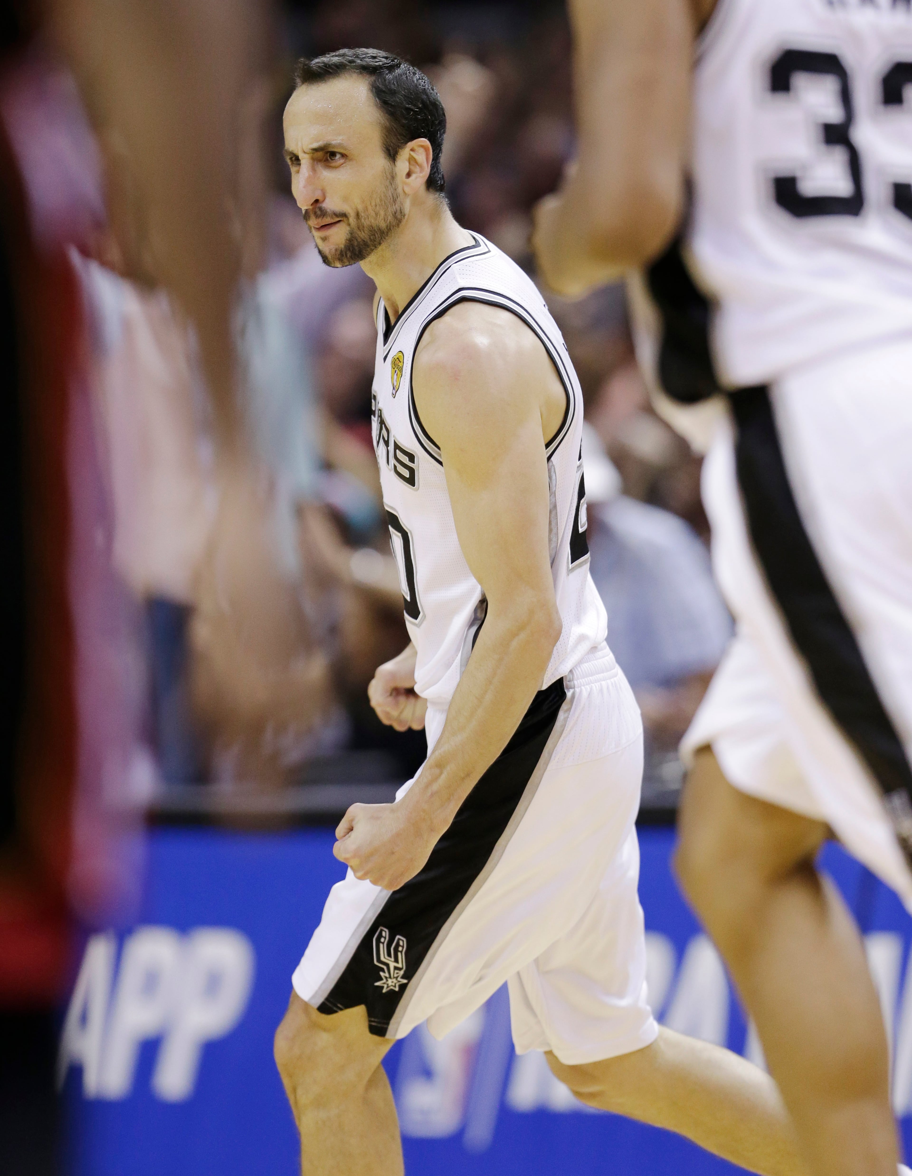 San Antonio Spurs guard Manu Ginobili (20) celebrates against the Miami Heat during the second half in Game 5 of the NBA basketball finals on Sunday, June 15, 2014, in San Antonio. The Spurs won the NBA championship 104-87. (AP Photo/David J. Phillip)
