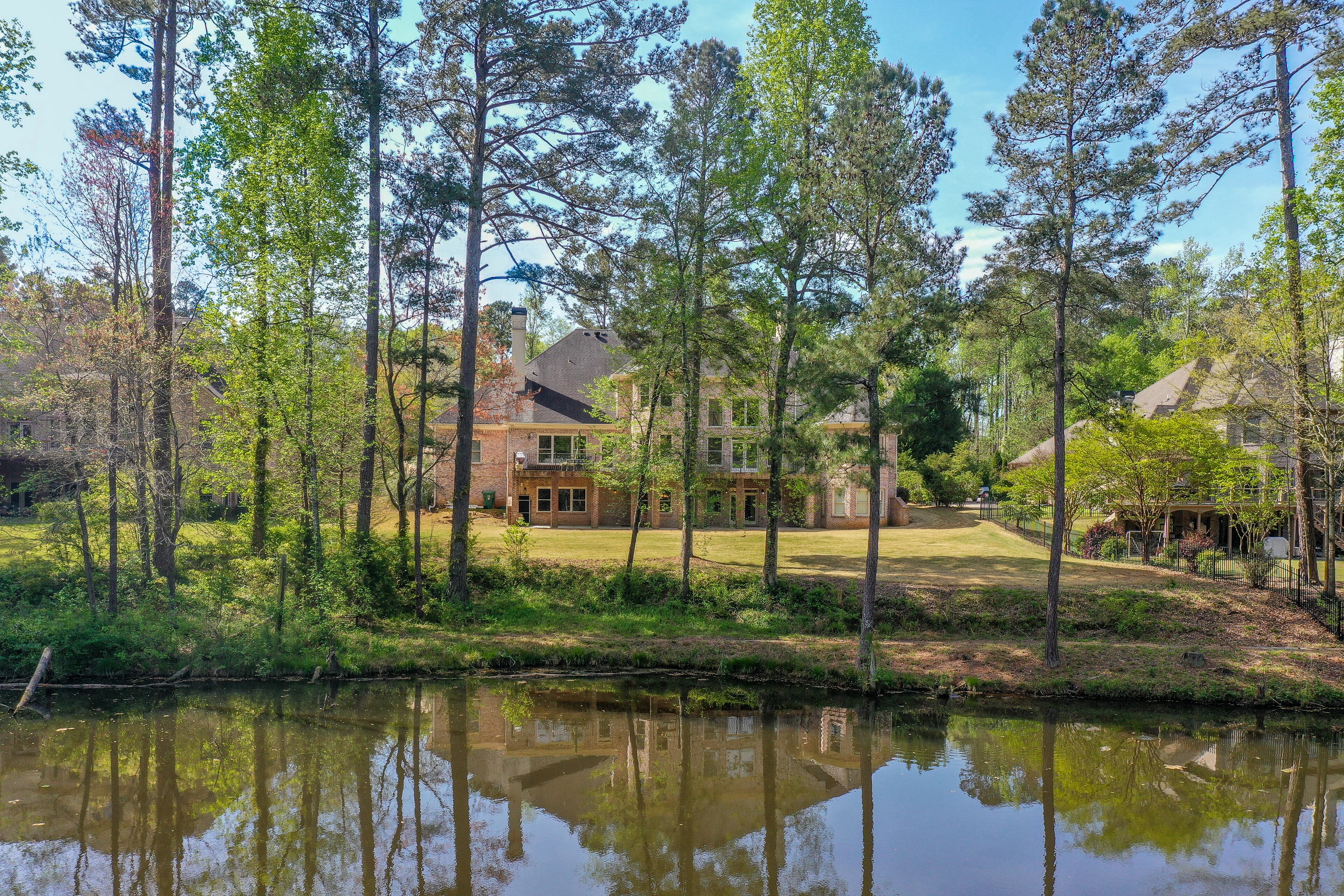 Backyard, lakefront view of this beautiful home. Text by Christela Becker