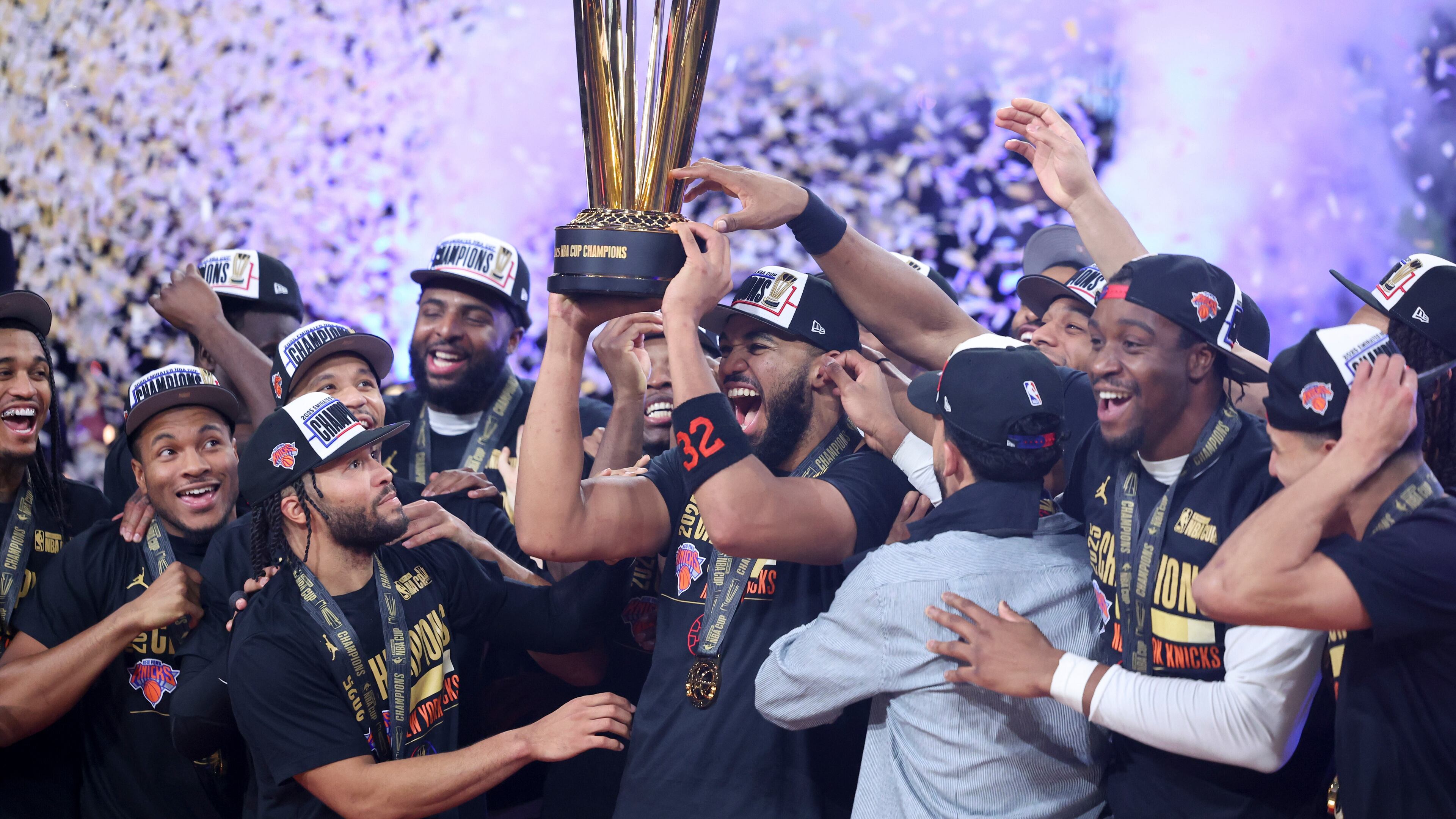 New York Knicks center Karl-Anthony Towns (32) celebrates with teammates after his team's victory against the San Antonio Spurs in the NBA Cup championship basketball game Tuesday, Dec. 16, 2025, in Las Vegas. (AP Photo/Ian Maule)